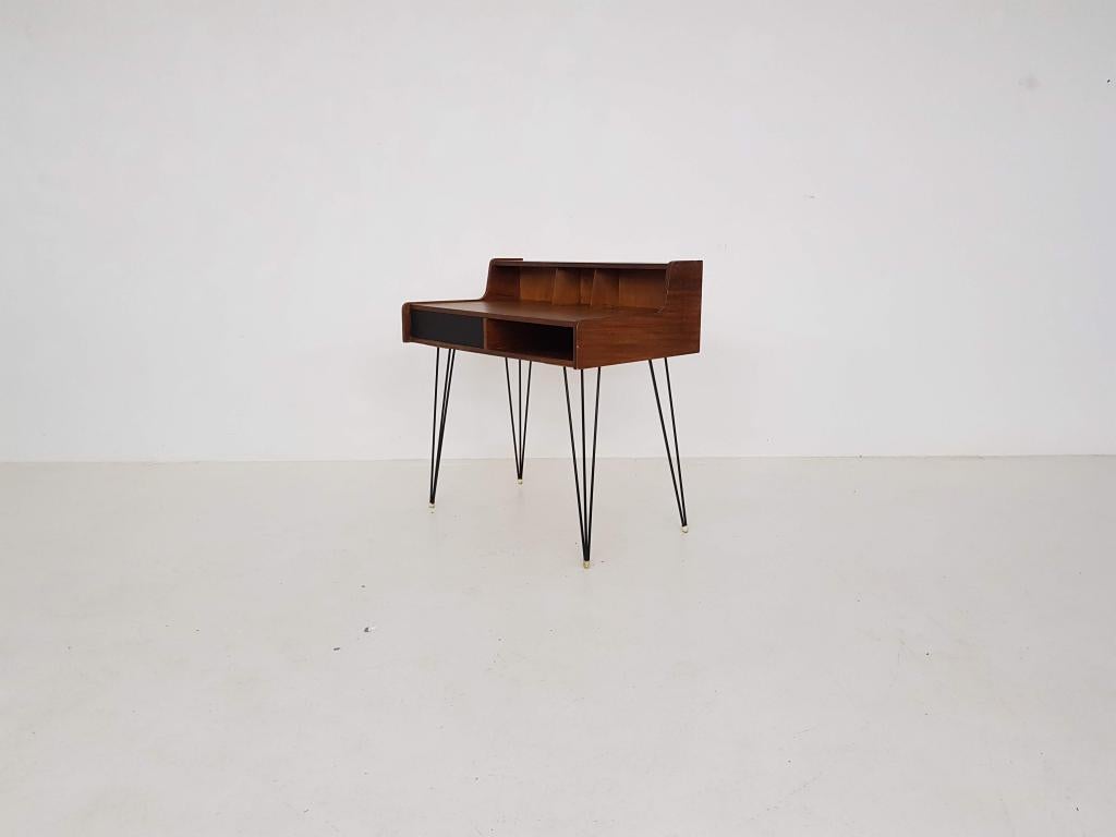Beautiful minimal teak desk on hairpins by Dutch designer Cees Braakman for Pastoe the Netherlands.

This little desk was part of a desk series that used different materials and designs to shape the legs. With this minimal design, Braakman wanted to