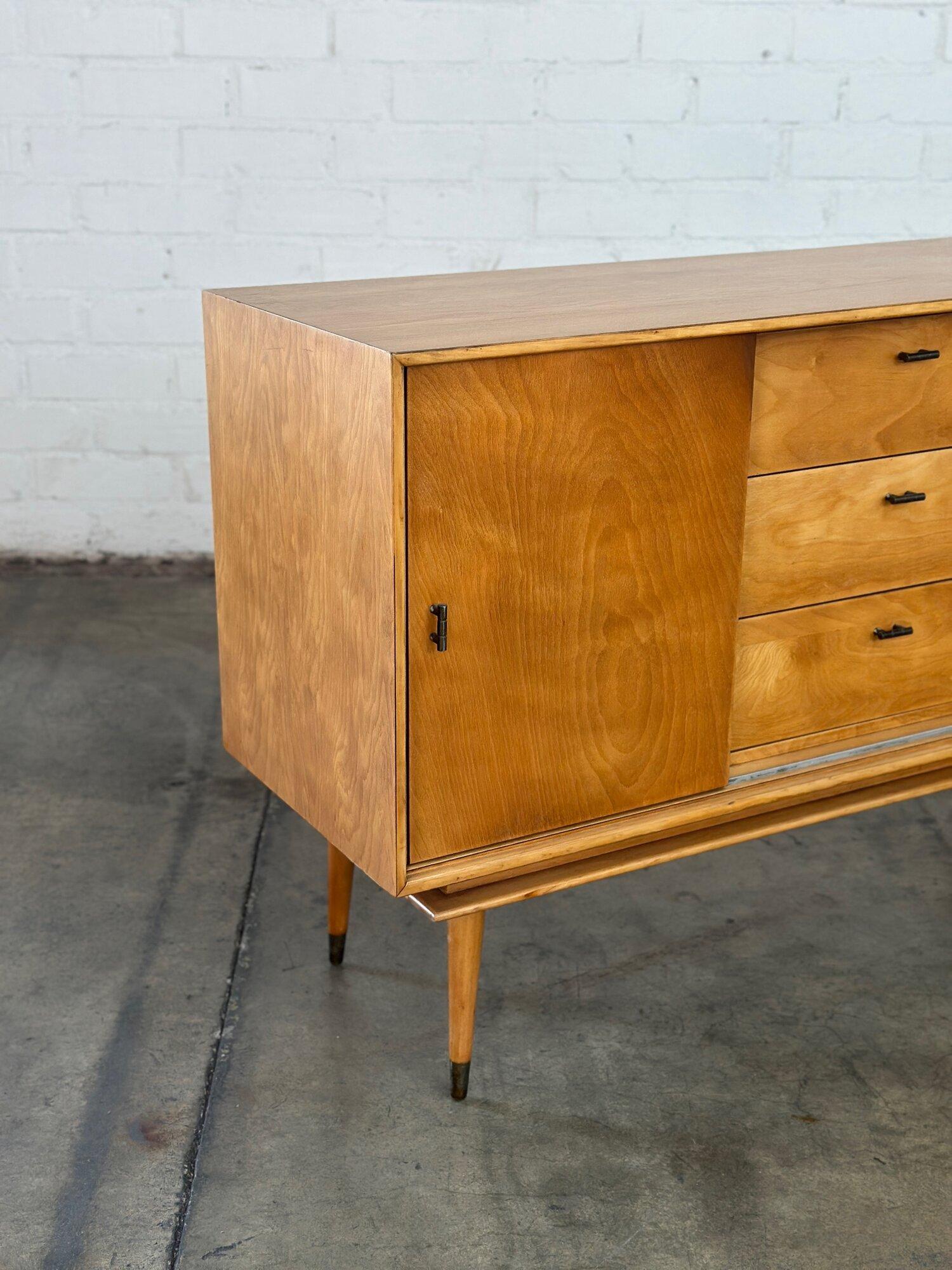 W48 D15.75 H30.5

Fully restored maple credenza very reminscnet of item by Paul McCobb. Items feature very nice grain patern, tapered angled legs, and still has orginal hardware.  Item features open and closed storage. Unit has one media hole in the