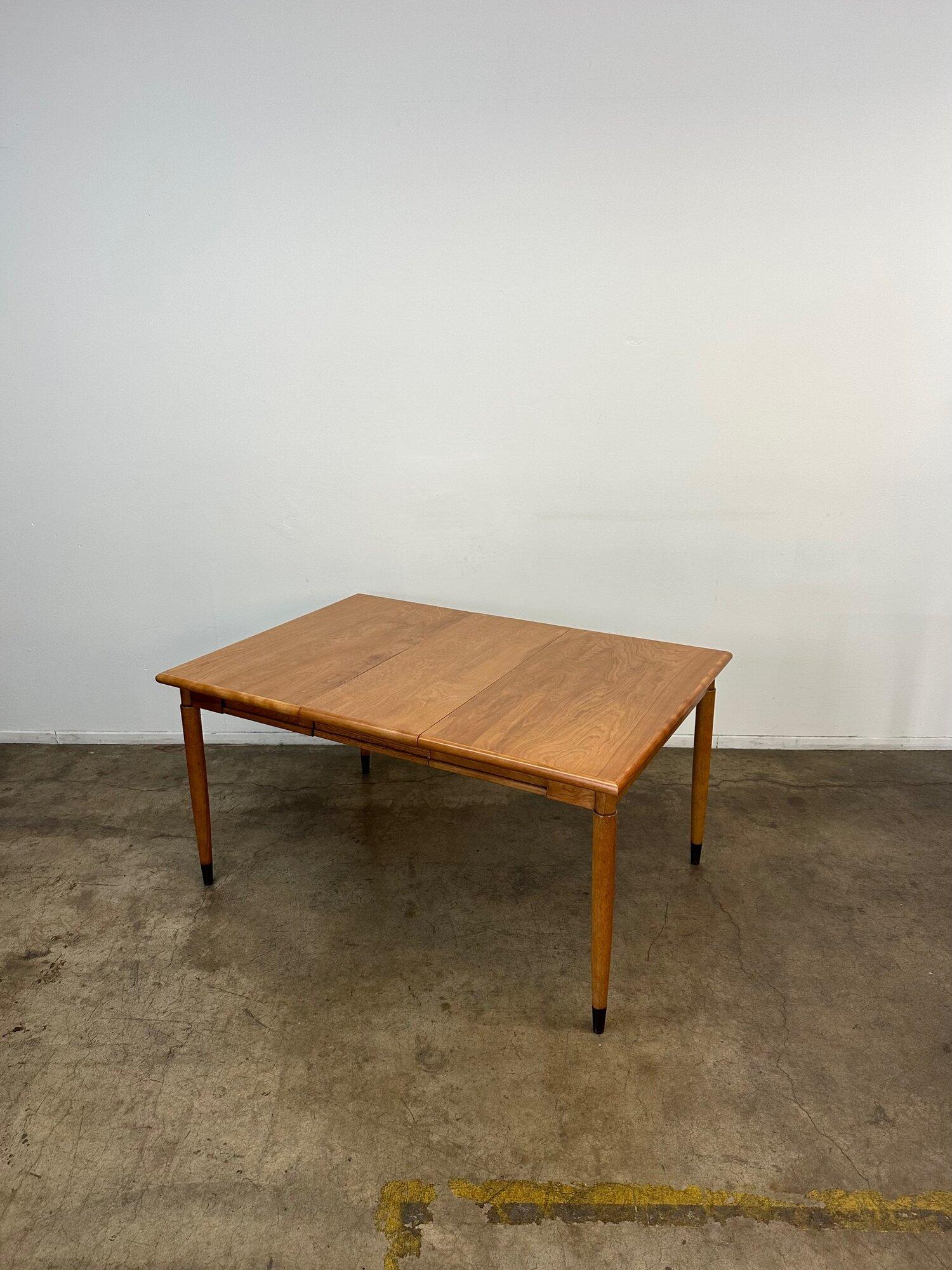 W42 W57 D39.5 H29

Fully restored midcentury dining table with one removable extension. Item is structurally sound and fully functional. Table features nice black laquer caps and item seems to be solid wooden construction.