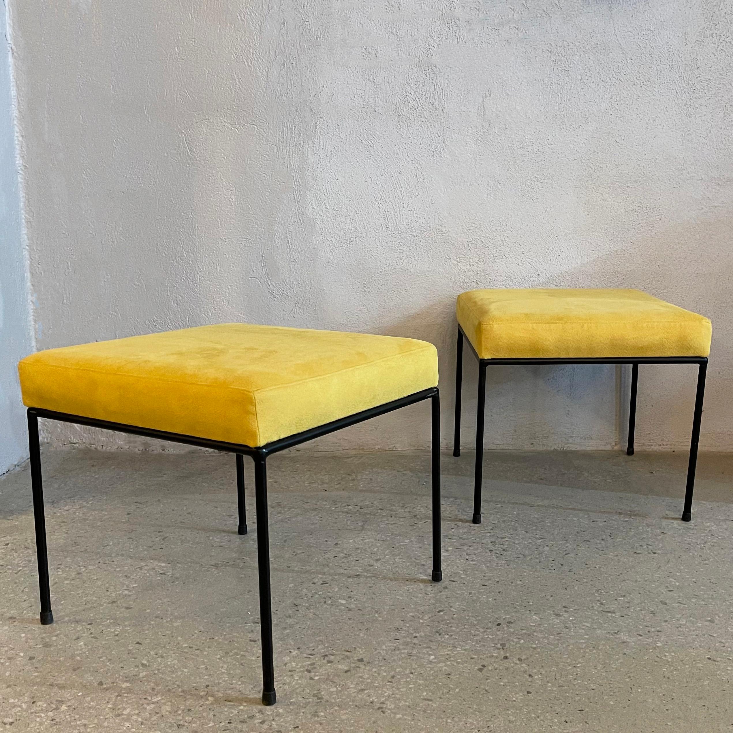 Pair of mid-century modern, square ottomans in the manner of Paul McCobb feature minimal wrought iron frames newly upholstered in saturated, tumeric yellow, ulrasuede. 