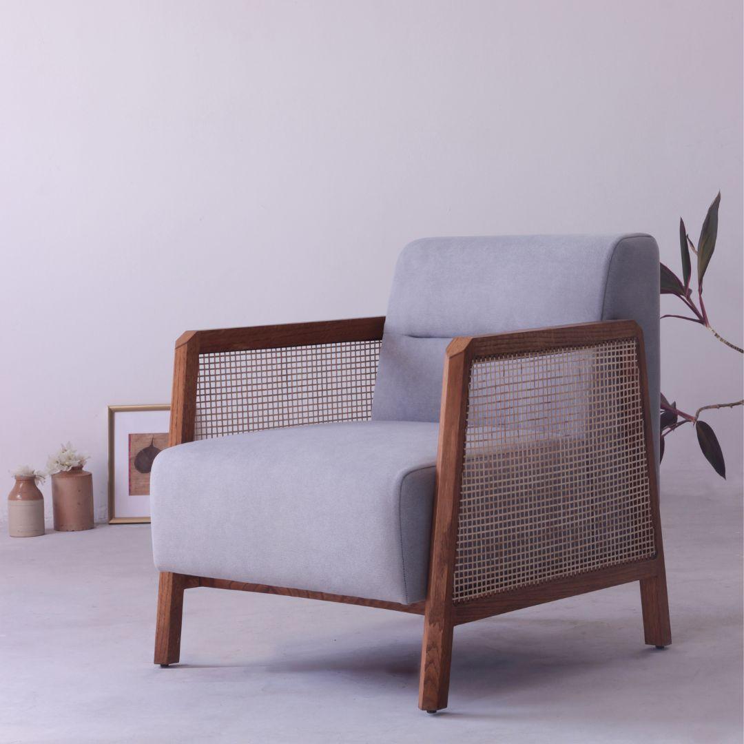 The Oasis solid wood armchair is the perfect addition to any home. With its airy and minimal aesthetic, the Lounge chair is perfect for Boho, minimal, and a variety of other interior styles. The handwoven cane sides, tactile details in solid wood,