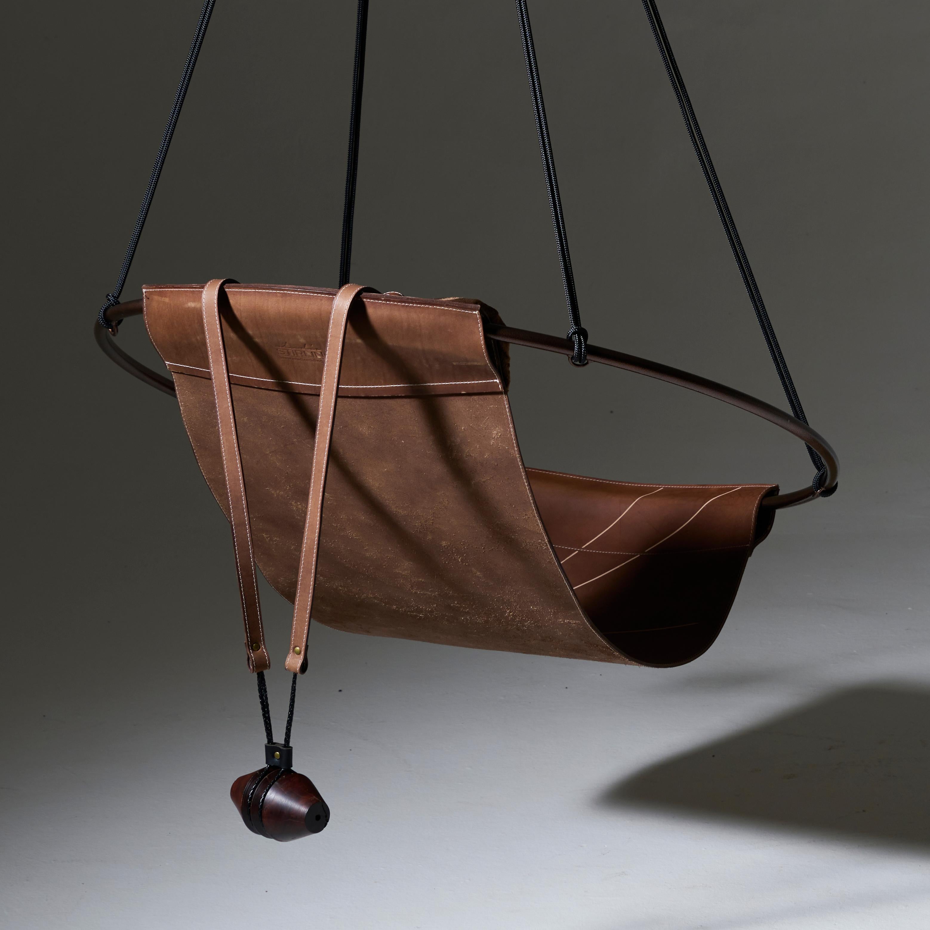 Stripped away from all excess, this hanging chair has a circular frame with the sheet of leather hanging loose within it, to create a sleek, sexy, and oh so comfortable experience. This chair’s clean lines and lightness makes it a perfect fit for