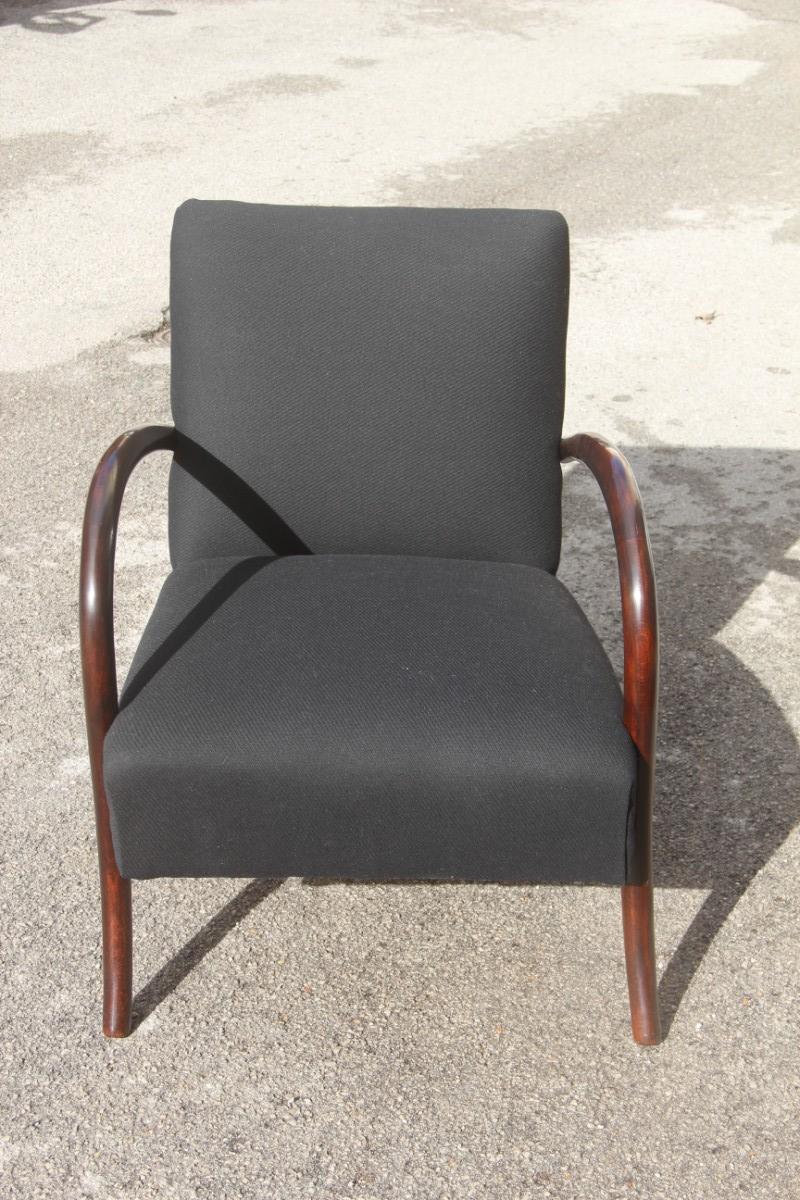Minimal old Italian armchair 1950s round rounded armrests black and brown.