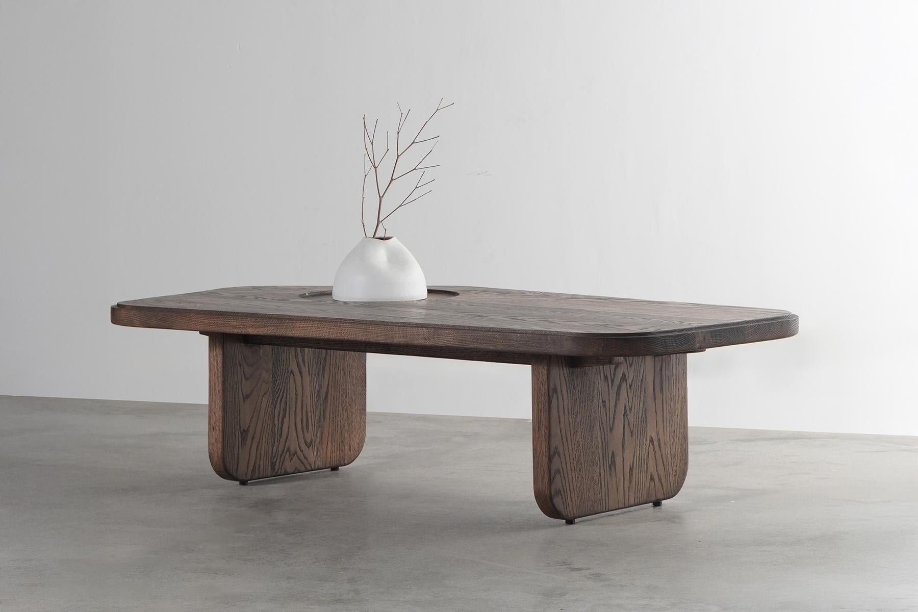 The Ishi coffee table is a stunning piece of furniture that is inspired by the katana, the Japanese sword. The table's organic shape and dip tray detail are reminiscent of the katana's blade, while its solid oak wood construction provides a sense of