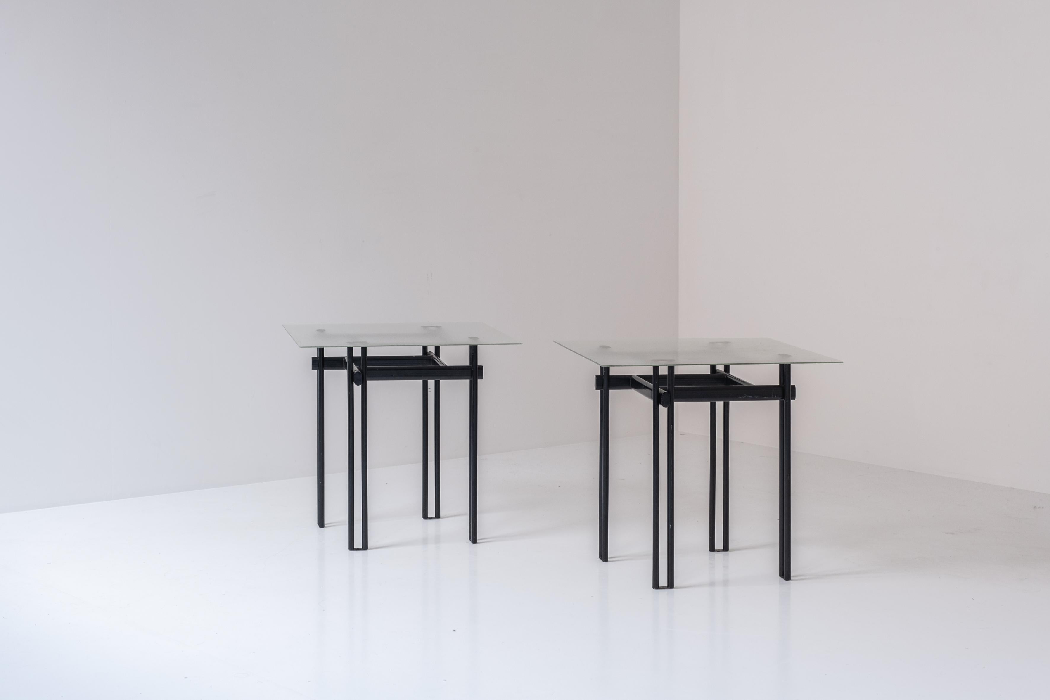 Minimal pair of identical side tables from Belgium, designed and manufactured in the 1980s. This pair features black lacquered steel frames with square frosted glas tops. Designer (for know) unknown. Presented in a good and original condition.