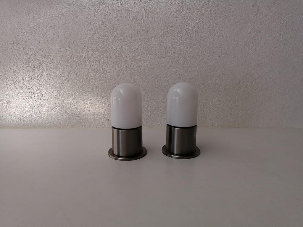 Minimal rare opal glass & metal pair of flush mounts by BEGA, 1970s, Germany.

Very nice high quality small wall lamps.

Lamps are in very good vintage condition.

These lamps works with E14 standard light bulbs. 
Wired and suitable to use in all