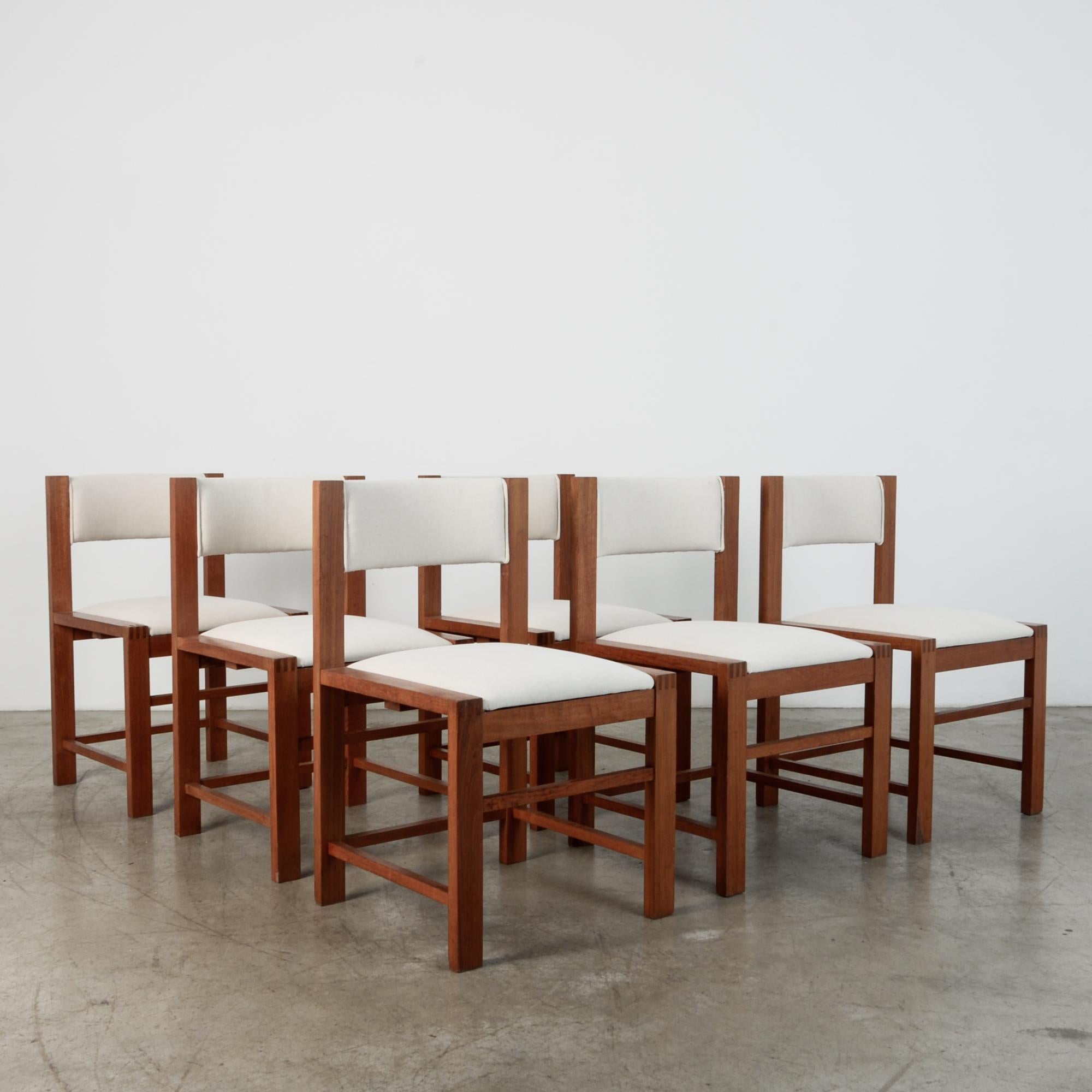 These minimal chairs are a distinctive Scandinavian design from circa 1970. With craftsman construction this sleek set is built to last in teak. The white fabric is a modern update, re- upholstered with a cotton-linen blend.