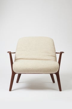 Minimal Style Insigne Armchair Sculpted in walnut wood finish, textiles seating