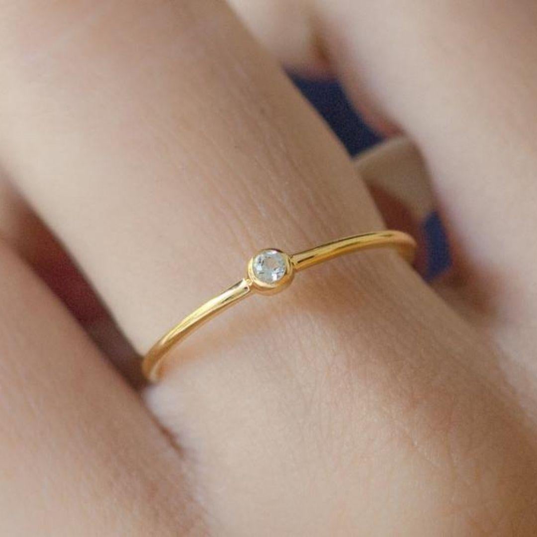Handmade item
Materials: Gold, Rose gold, White gold
Gemstone: Aquamarine
Gem color: Blue
Band Color: Gold

Dainty thin gold ring with small round shape aquamarine gemstone. Stackable ring for everyday wear, matching any style and occasion. Classic
