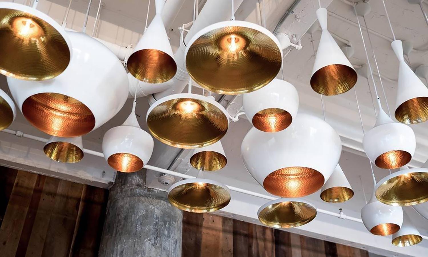 Minimal Tom Dixon beat wide white pendant brass light fixture, Contemporary. Gorgeous piece. Retails for 575 USD. 

The beat wide pendant by Tom Dixon brings the rustic, down-to-earth appeal of traditional Indian cooking pots and water vessels to