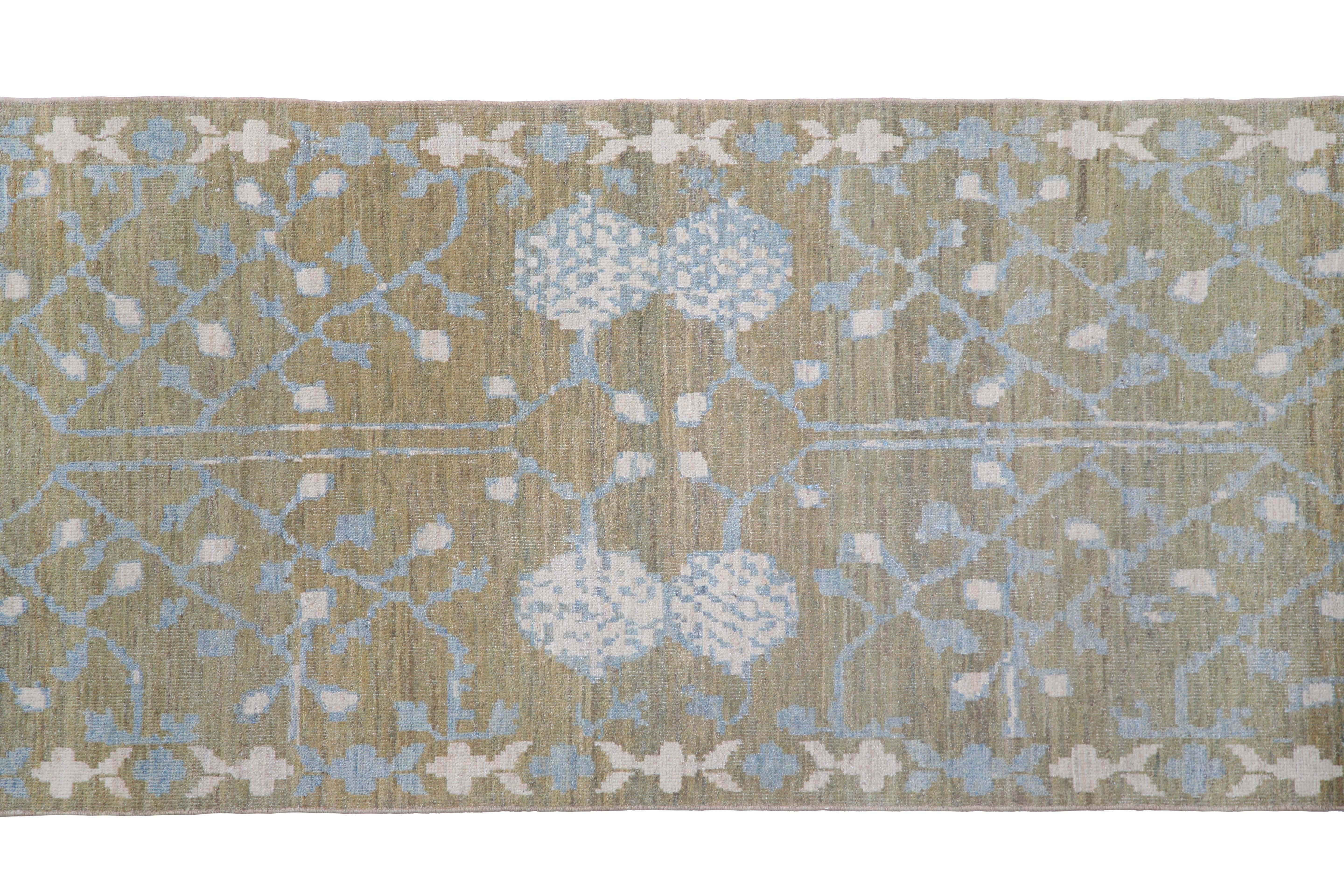 Introducing our exquisite handmade Turkish Sultanabad runner rug! Measuring 3'4'' by 10'10'', this rug is the perfect addition to any space. Featuring a stunning olive green background and pops of cream and blue in the traditional design, this rug
