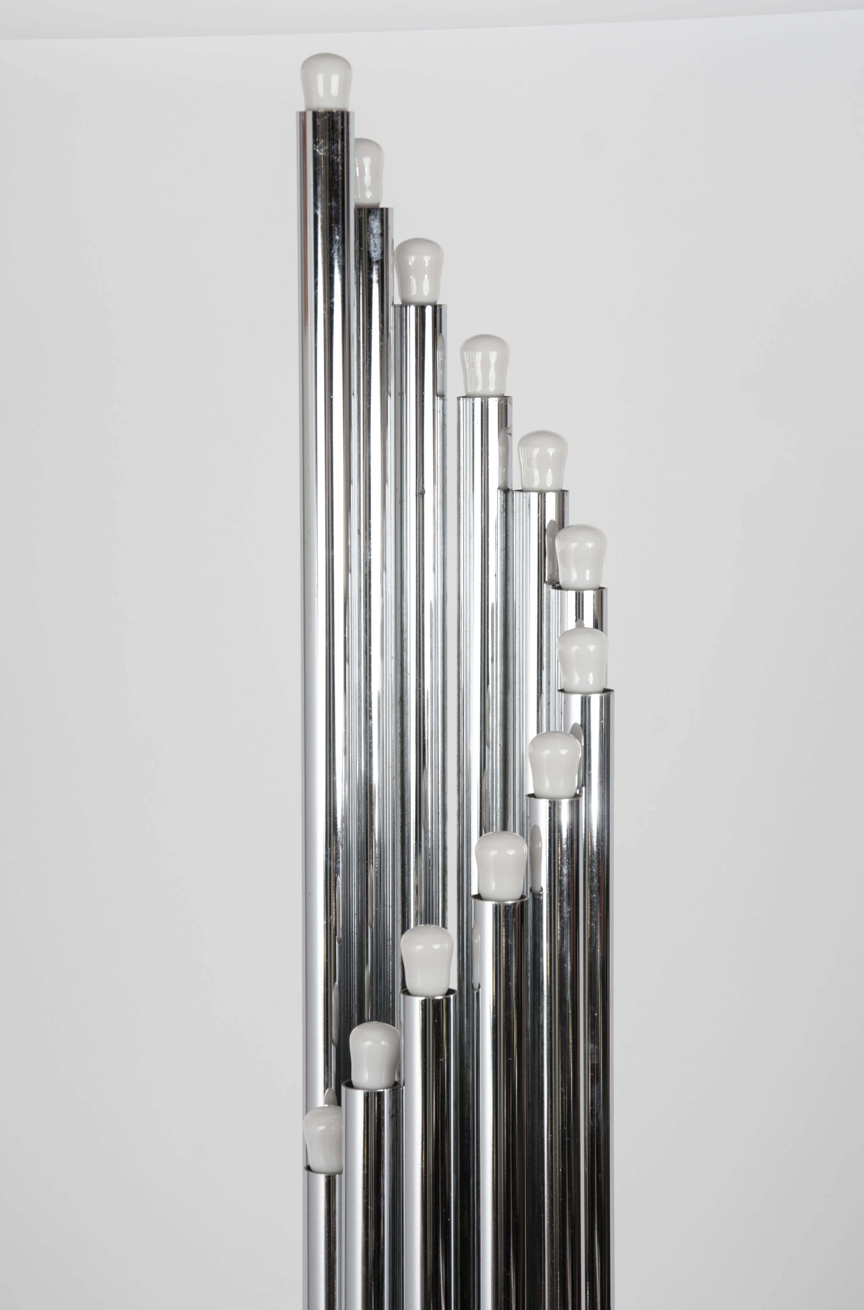 Minimalist chrome tubular floor lamps with an array of ascending or descending tubular lights spiraling from a round plinth like organ pipes. It is compact and sculptural design from the 1960's.