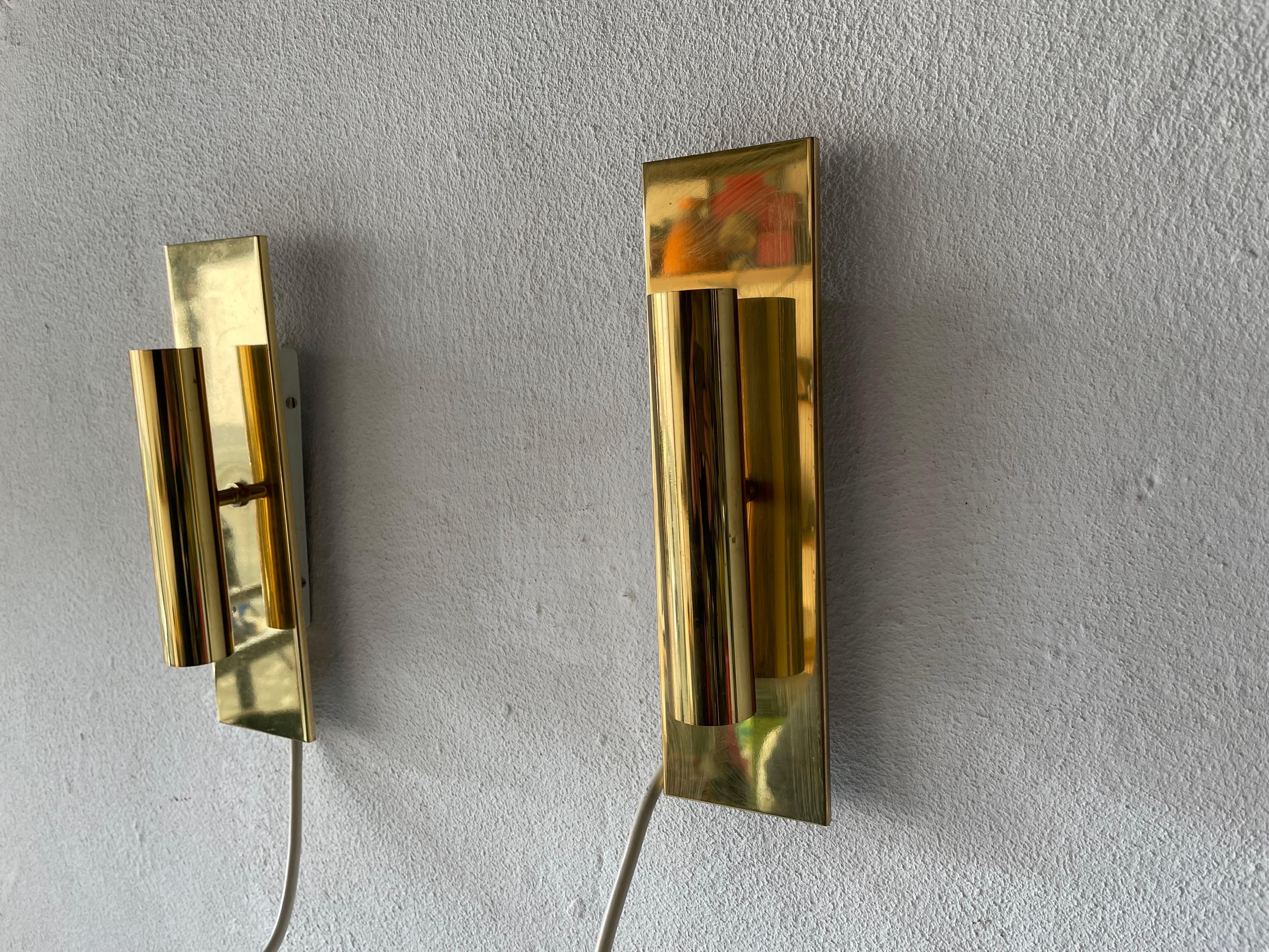 Minimalist 2-Side Brass Pair of Sconces by Doria, 1960s, Germany

Very elegant and Minimalist wall lamps
Lamp is in very good condition.

These lamps works with 2xE14 standard light bulbs. 
Wired and suitable to use in all countries. (110-220