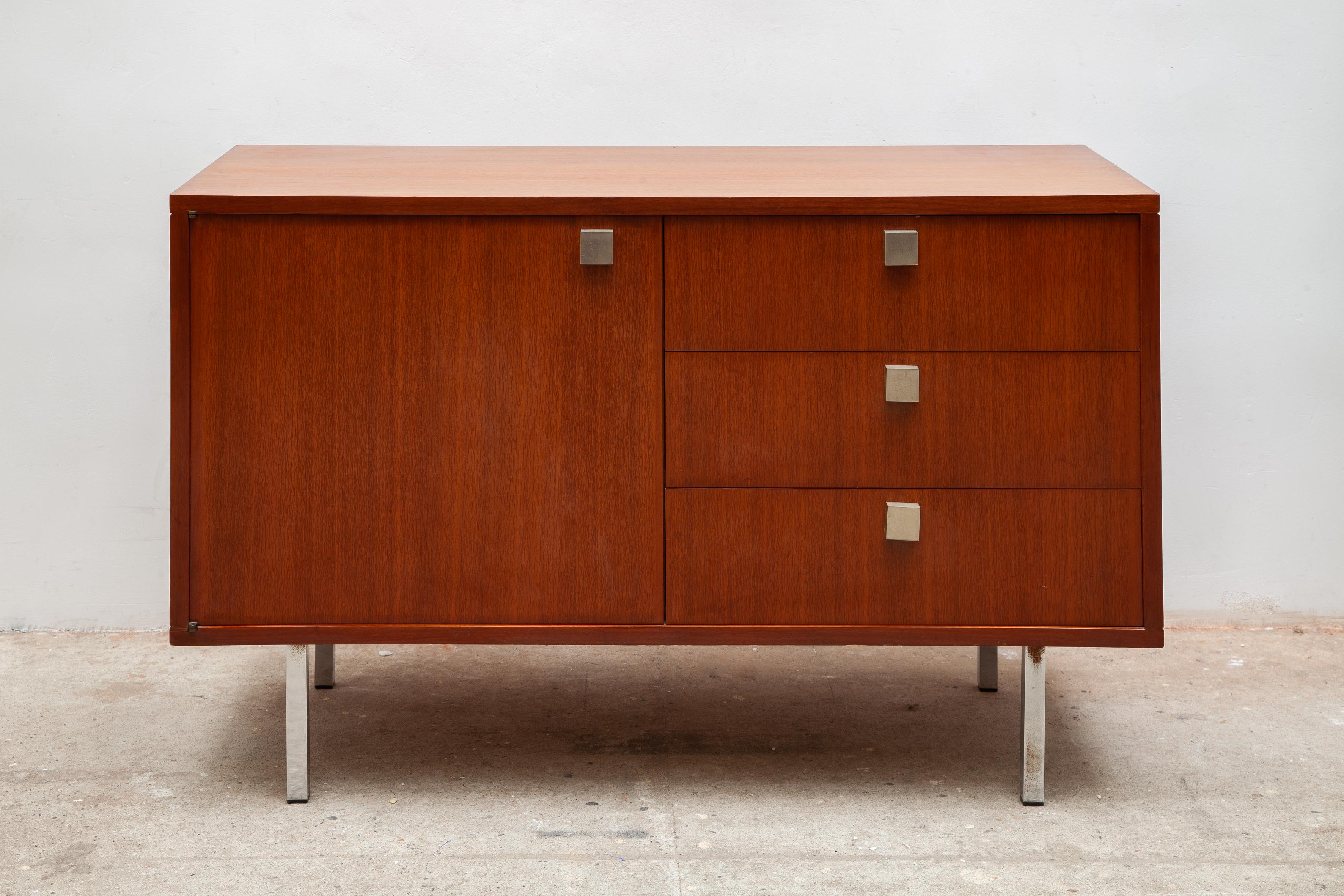 Small minimalist sideboard by Hendrickx, Belform 1962, Belgium. Small cabinet with one adjustable shelve and three dovetail drawers. Its finished with square metal doorknobs and a nice pattern veneer on the in- and outside, metal chrome legs.