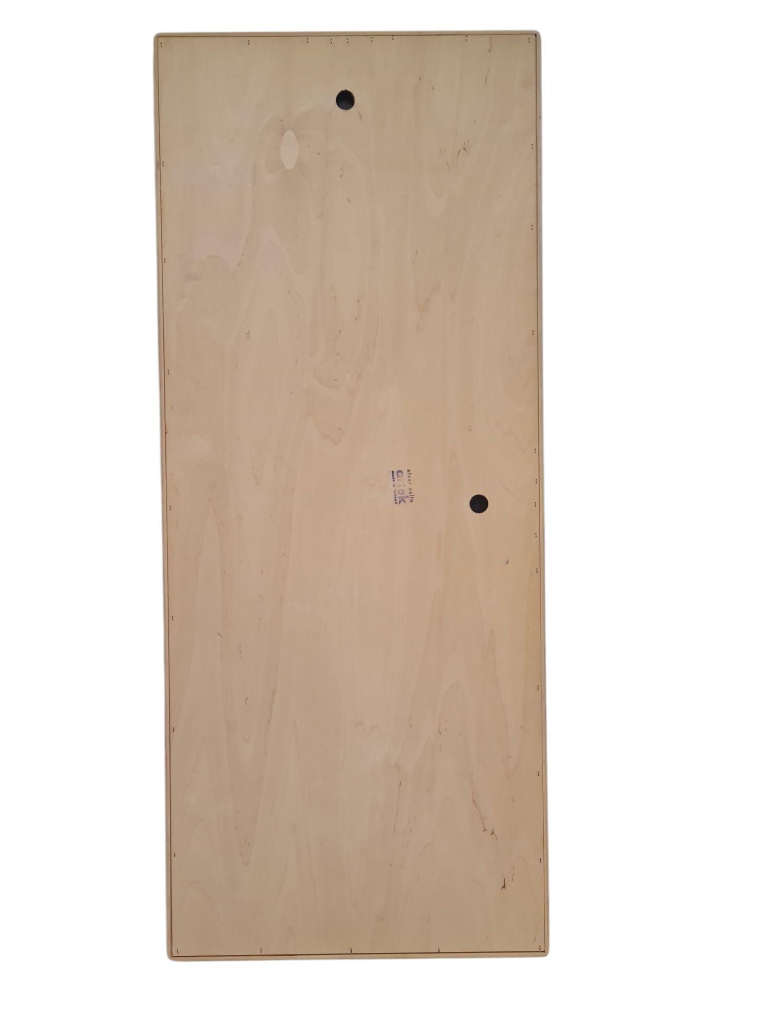 An iconic mirror designed by Alvar Aalto and retailed by Artek in Finland.  Very minimalist with straight lines and finger joints. The mirror has holes in the back in a way that enables one to hang it both vertically or horizontally. 

This mirror