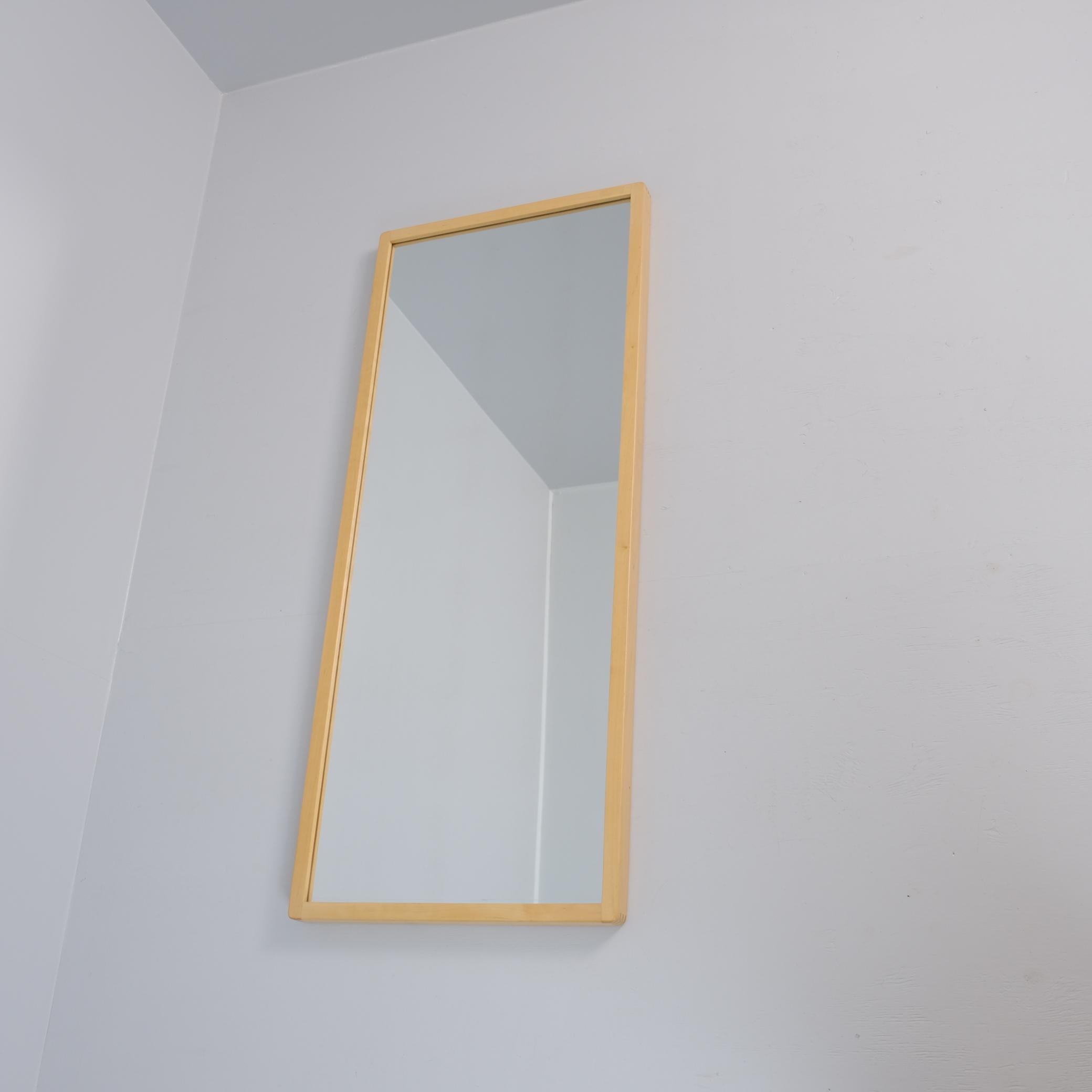 An iconic mirror designed by Alvar Aalto and retailed by Artek in Finland.  Very minimalist with straight lines and finger joints. The mirror has holes in the back in a way that enables one to hang it both vertically or horizontally. 

This mirror