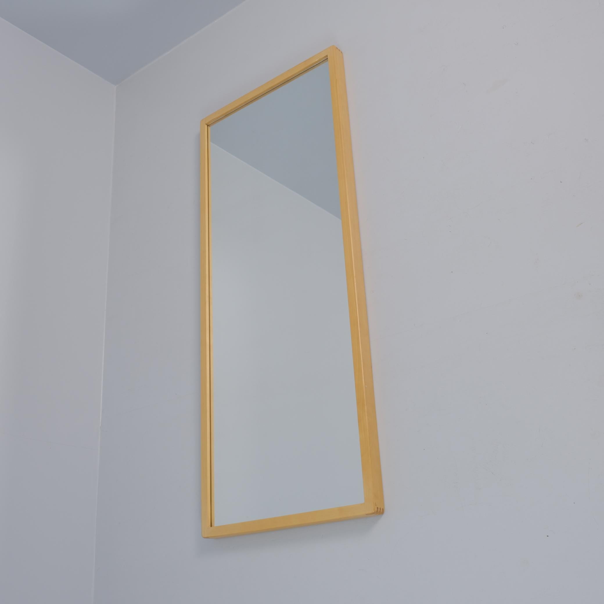 An iconic mirror designed by Alvar Aalto and retailed by Artek in Finland.  Very minimalist with straight lines and finger joints. The mirror has holes in the back in a way that enables one to hang it both vertically or horizontally. The hanging