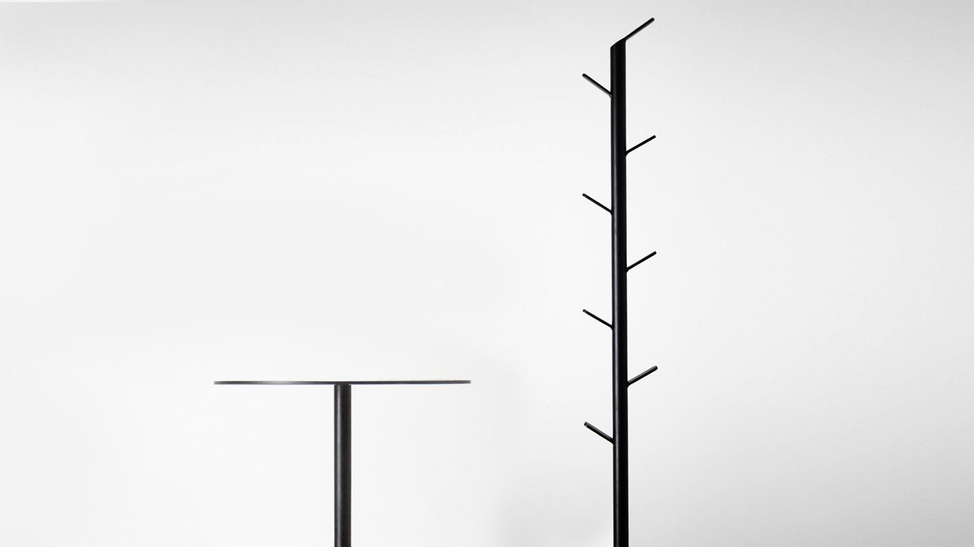 minimalist and contemporary black coat rack made of metal and concrete base For Sale 2