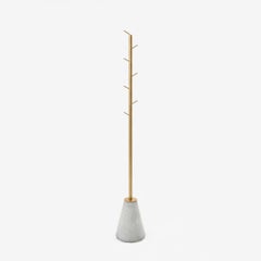 minimalist and contemporary coat rack made of brass and concrete base
