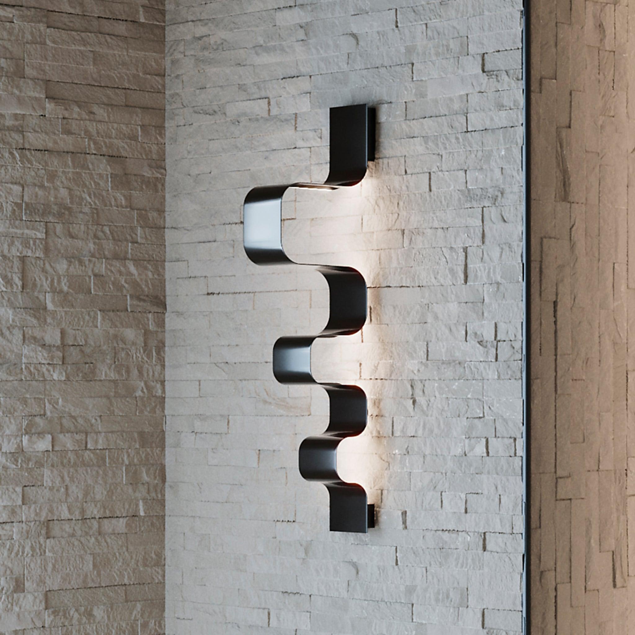 Ribon Wall Lamp Black is a modern wall lamp in brass with black finish and a futuristic flair.
The sophisticated wall lamp emanates a warm and seductive light into the space, resulting from simple materials and simple construction.
Luxurious yet