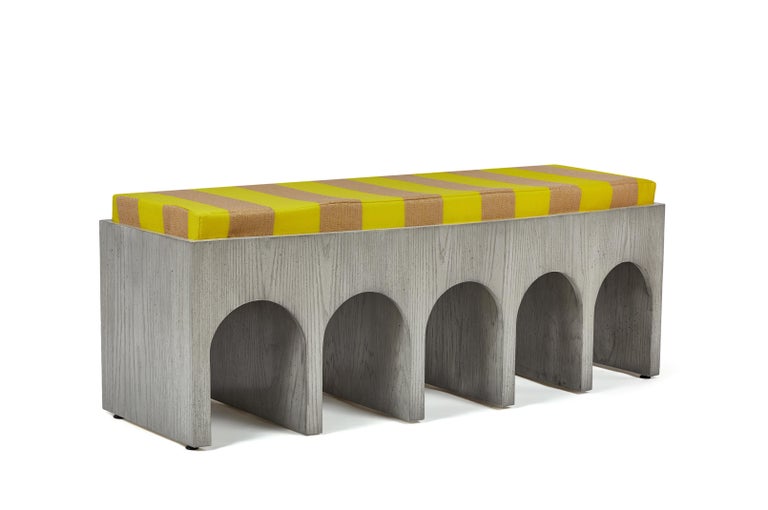 Martin and Brockett's Arcade bench is a nod to the ancient Roman architectural form, a succession of contiguous arches supported by columns. The bench has a slight convex curvature at the face. Shown in our Italian gray finish.

Cushion is C.O.M.