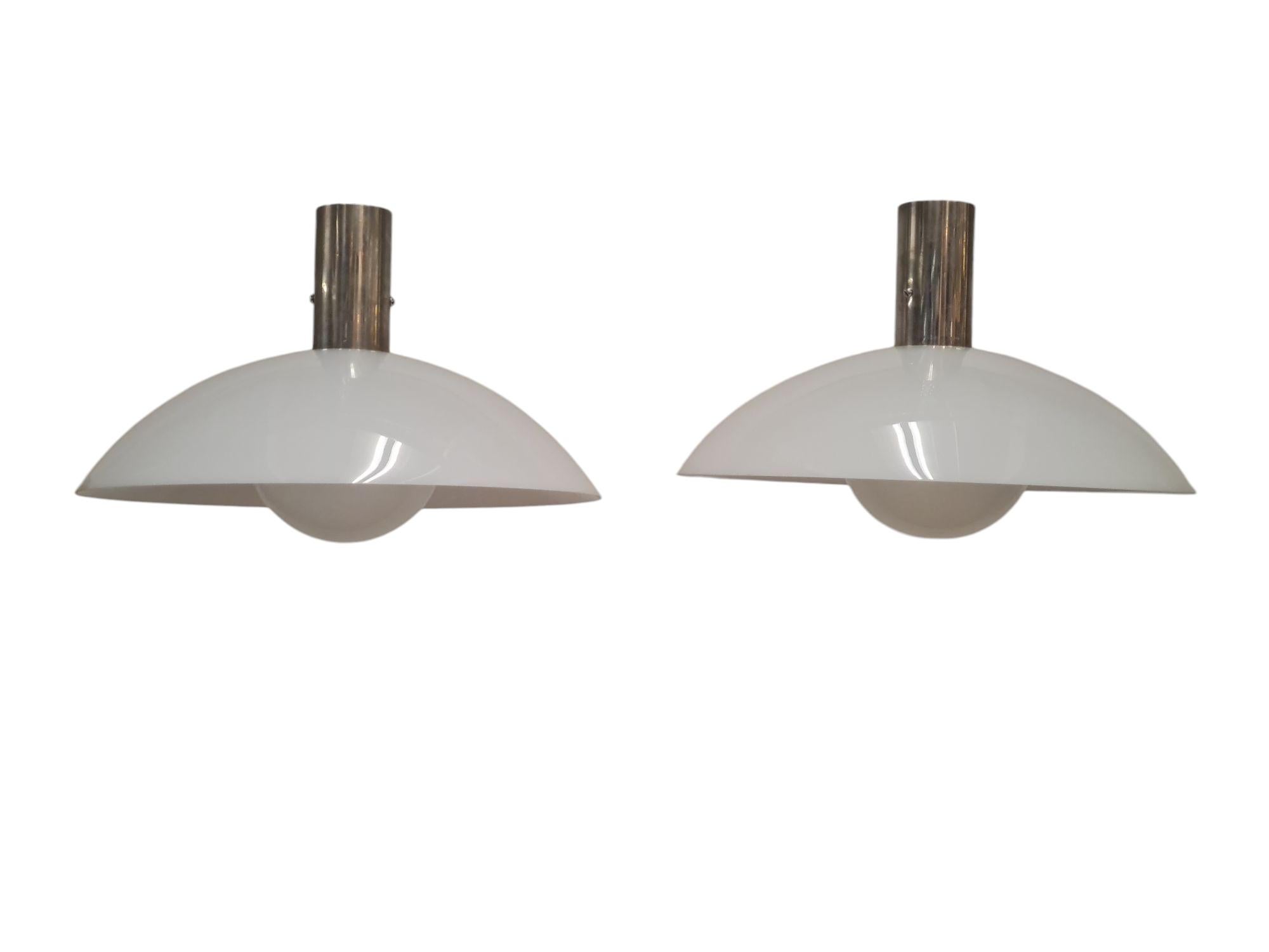 An elegant minimalist art deco pair of ceiling pendants by Paavo Tynell and manufactured by Taito from the 1930s. This pair, along other lamps on our listings, came from the Ilveslinna building in Jämsänkoski and were all commissioned by Paavo