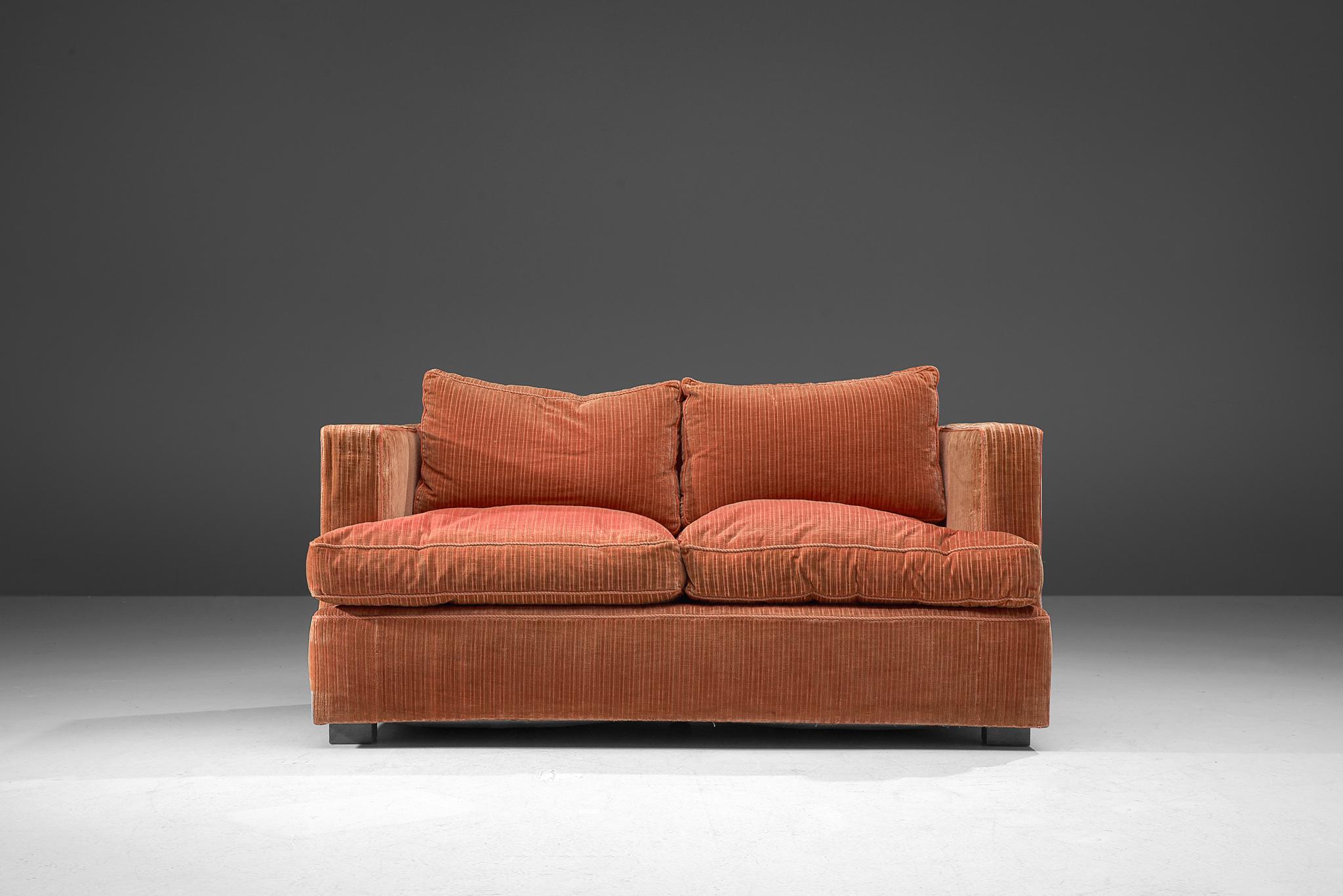 Sofa, corduroy velvet, wood, Italy, 1970s

This delicate sofa has a cozy and bulky appeal. An orange to peach velvet has been used to cover the seating. The textured surface of the fabric, consisting of vertical lines, adds a graphical touch to the