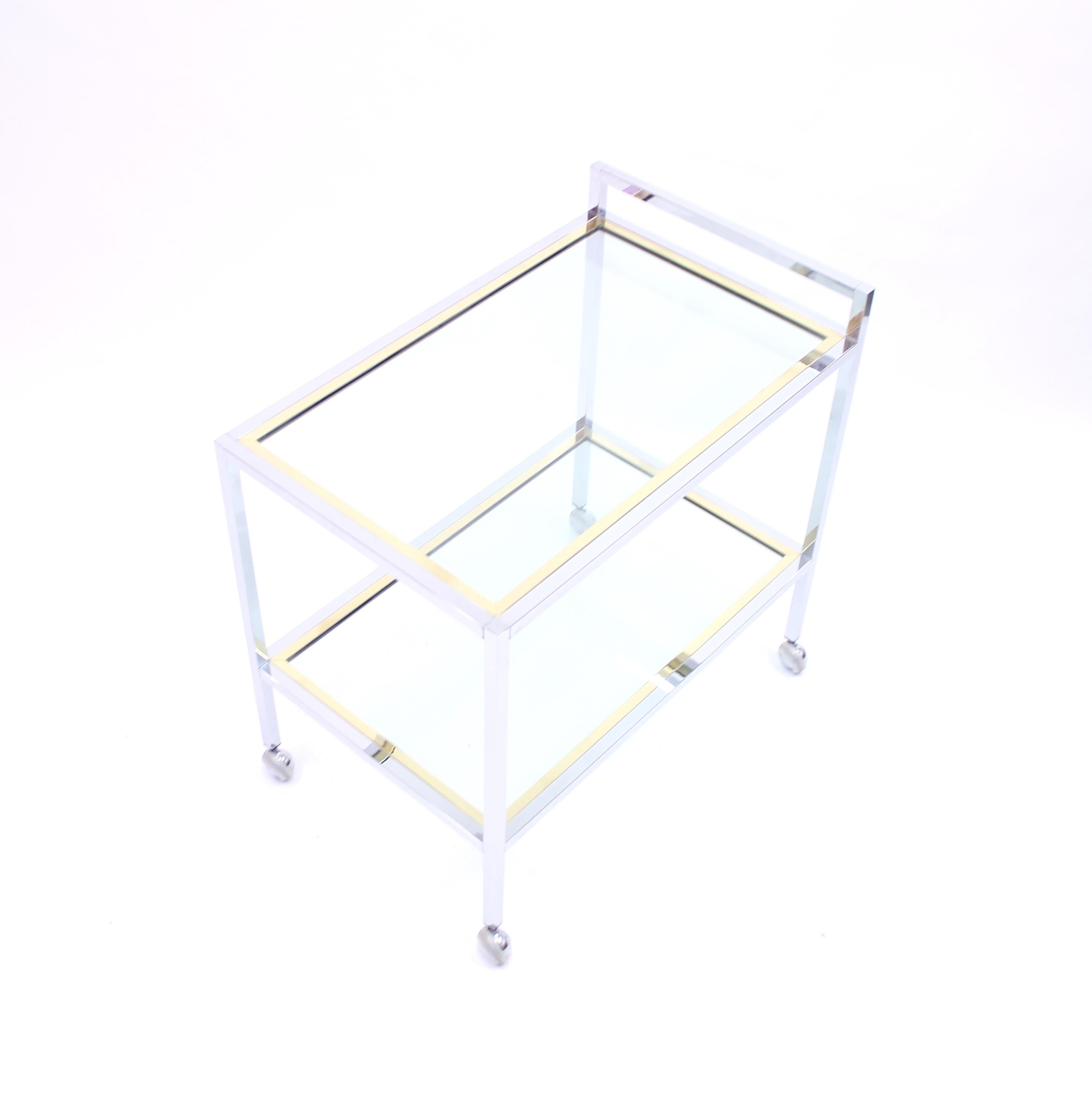 Minimalist bar trolley or cart in brass, chrome and glass from the 1970s attributed to Italian manufacturer Romeo Rega. Very good condition with hardly any ware.