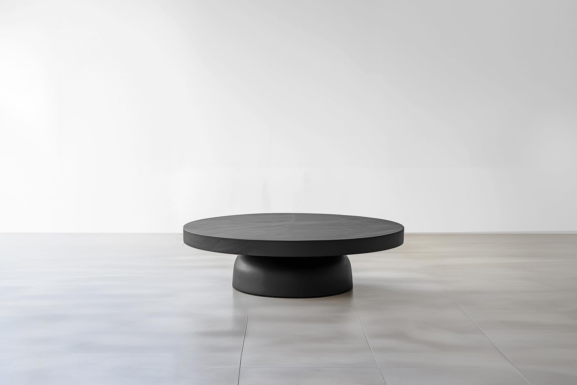 Minimalist Black Round Coffee Table - Sleek Fundamenta 31 by NONO

Sculptural coffee table made of solid wood with a natural water-based or black tinted finish. Due to the nature of the production process, each piece may vary in grain, texture,