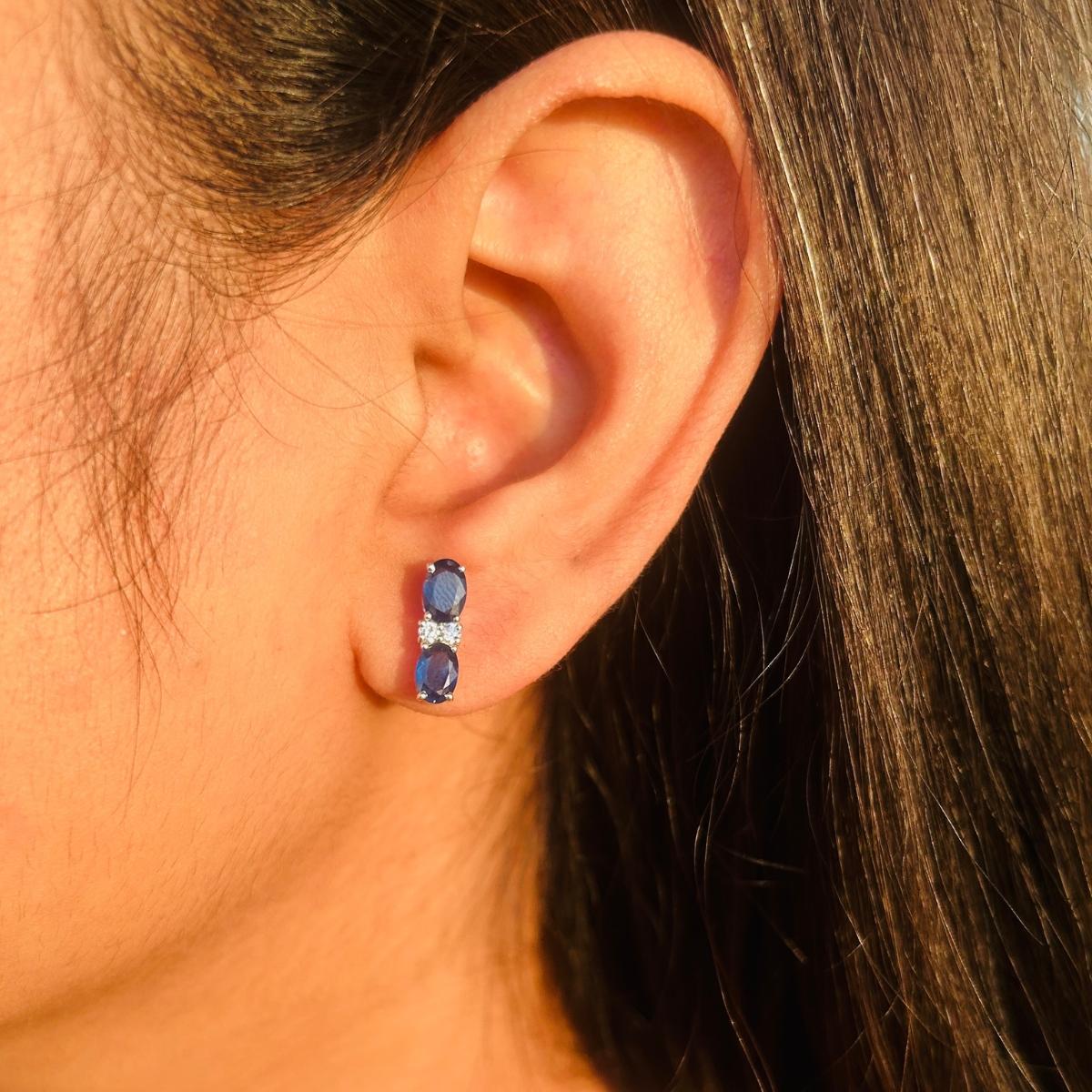 Minimalist Blue Sapphire & Zirconia Stud Earrings in sterling silver to make a statement with your look. You shall need stud earrings to make a statement with your look. These earrings create a sparkling, luxurious look featuring oval cut natural