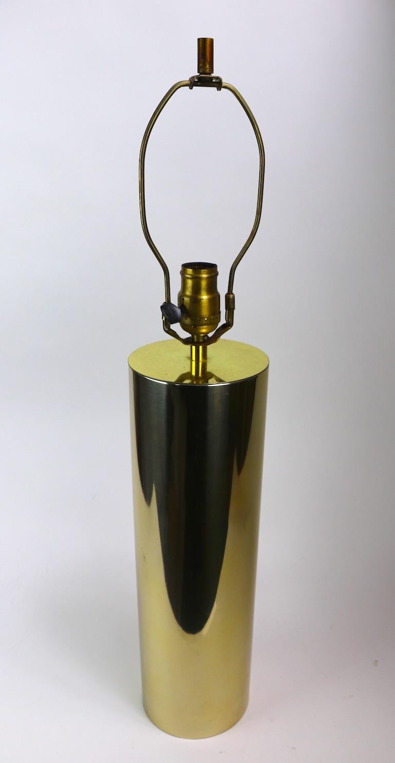 Stylish brass color table lamp, architectural International style design, clean, original and working condition. Shade not included. H to top of cylinder 16.5 inch x total H 27 inch.