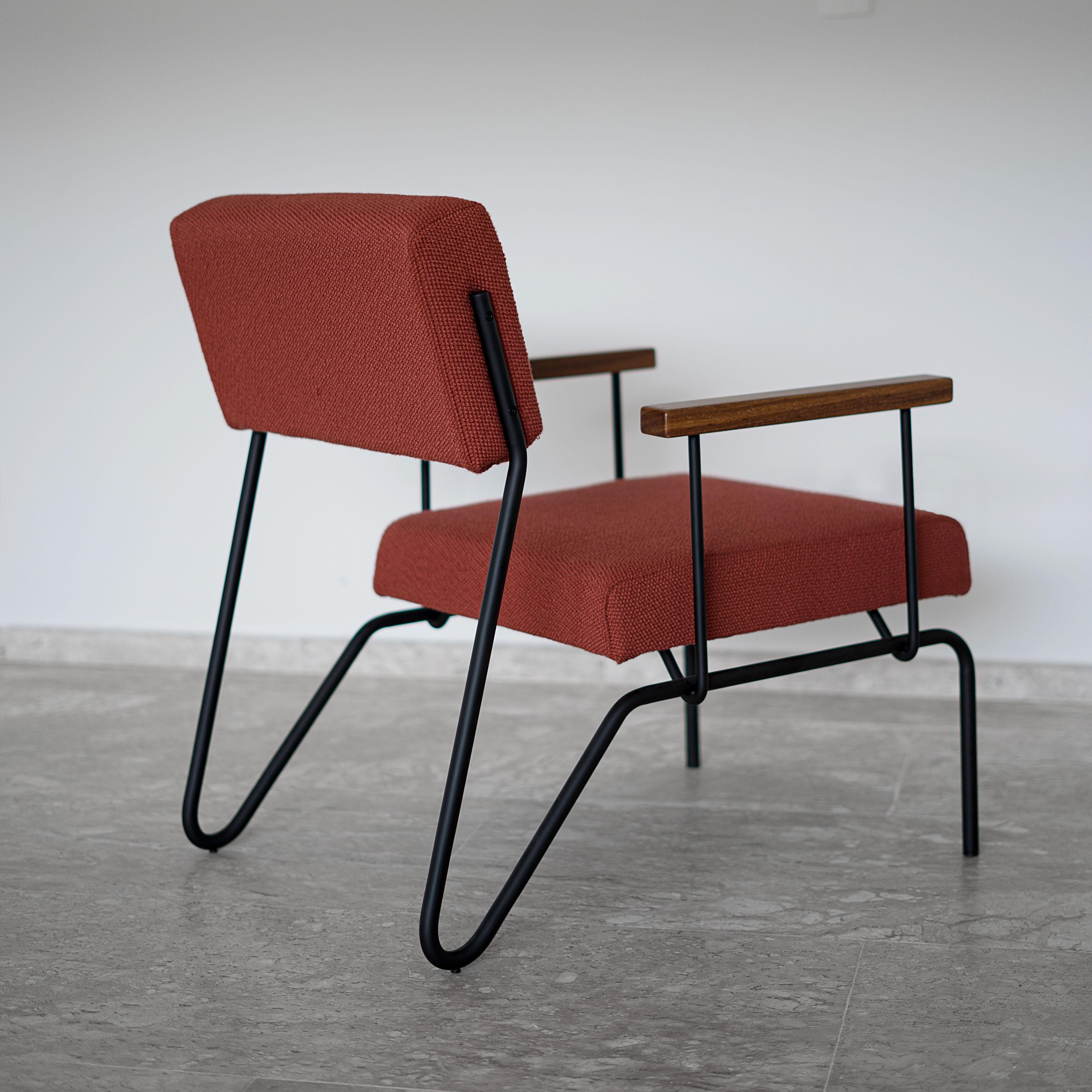 This award winning Minimalist armchair in steel, solid wood and leather is designed with a Classic and geometric reasoning. 
The continuity of the structural lines suggests fluidity. The backrest allows a smooth movement and just like the seat, it