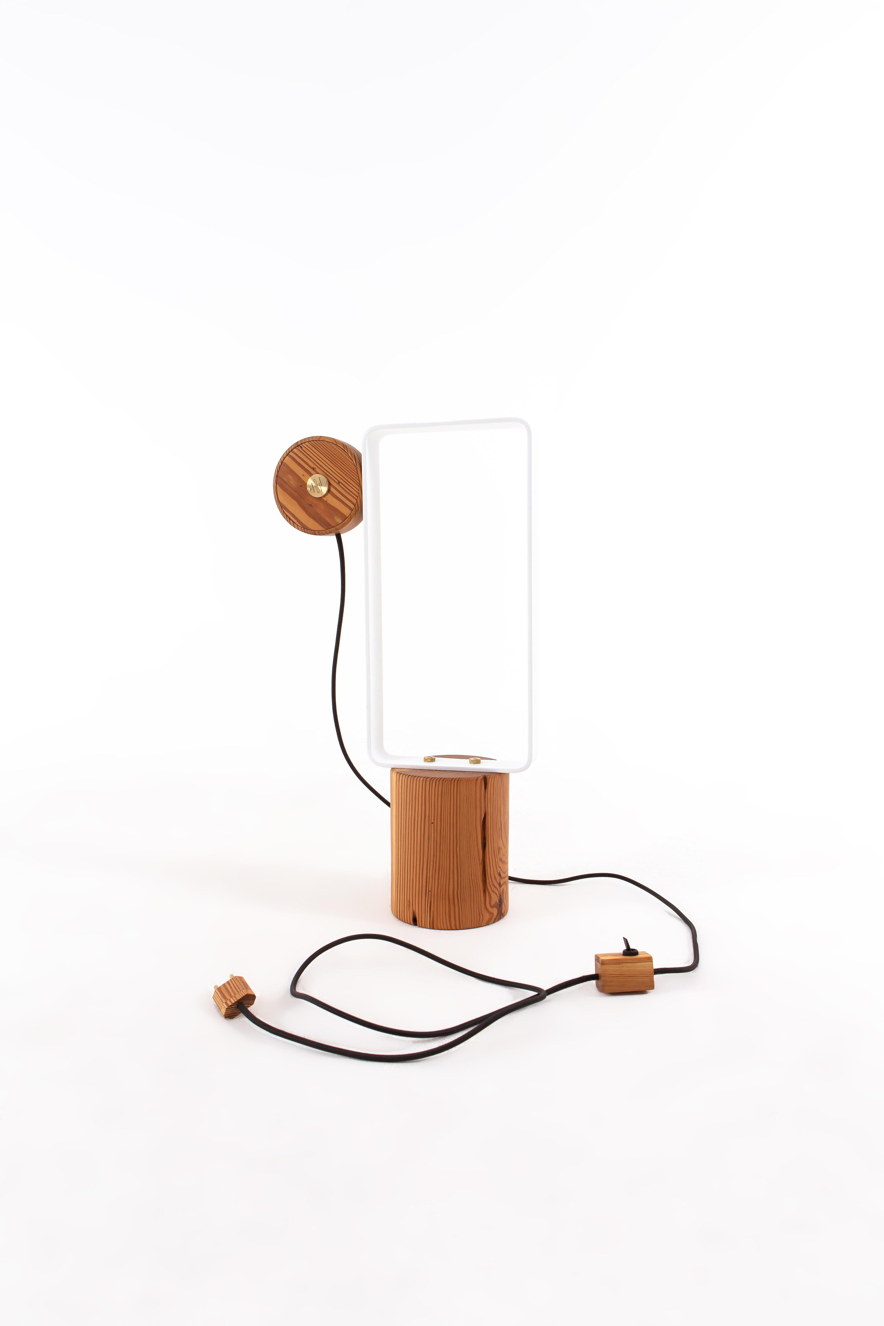 About the Lamp:

The Lamp suggests an innovative usability for its light bulb by using a magnetic system. A magnet that is underneath the wood base can be positioned all over the metallic base, allowing several types of configurations, being also