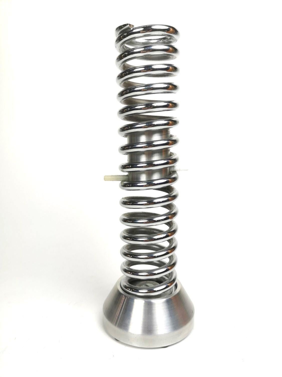 Spring coil shaped designer candelabra. The height is adjustable to the size of the candle that it holds.