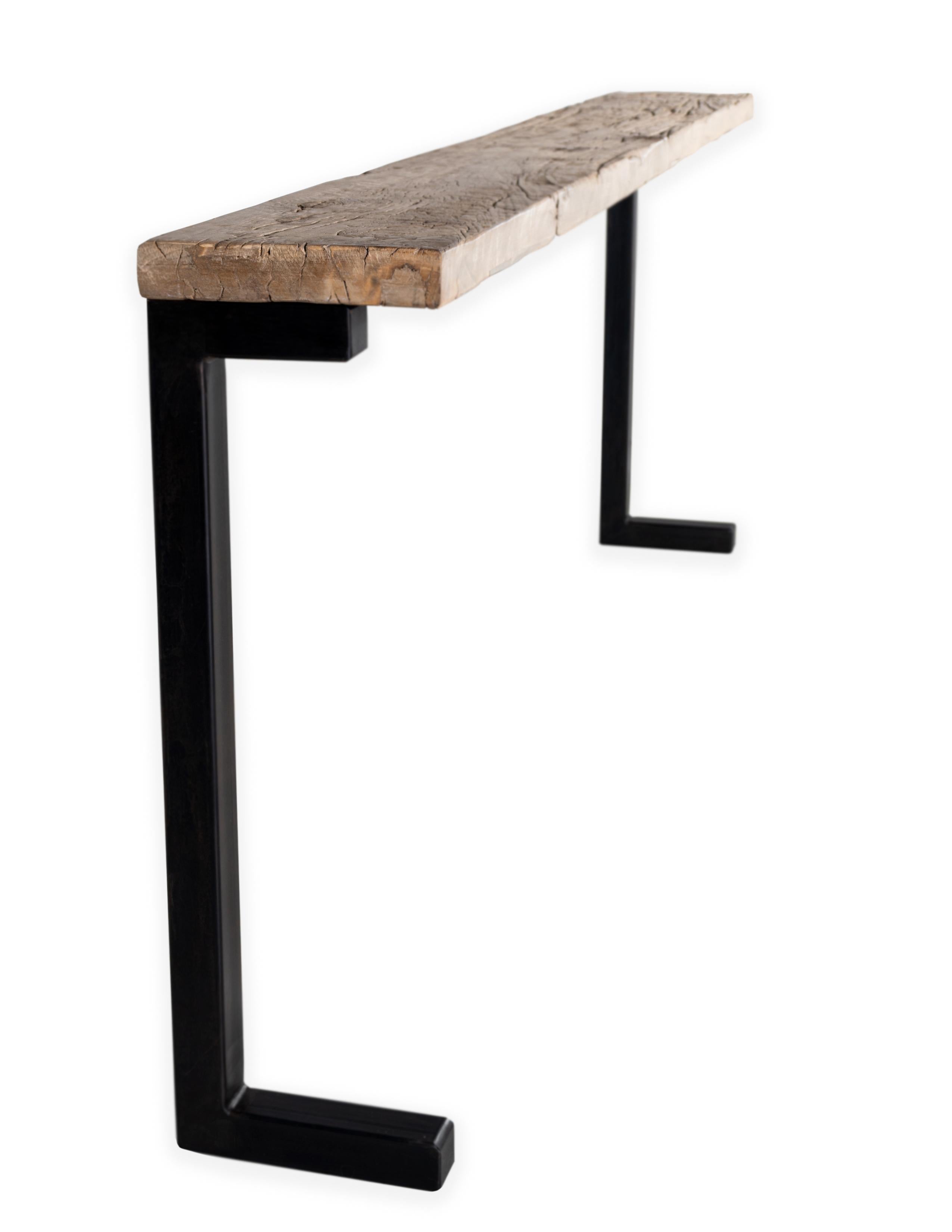 Minimalist console with a reclaimed bleached elm top and an ebony patina steel base.