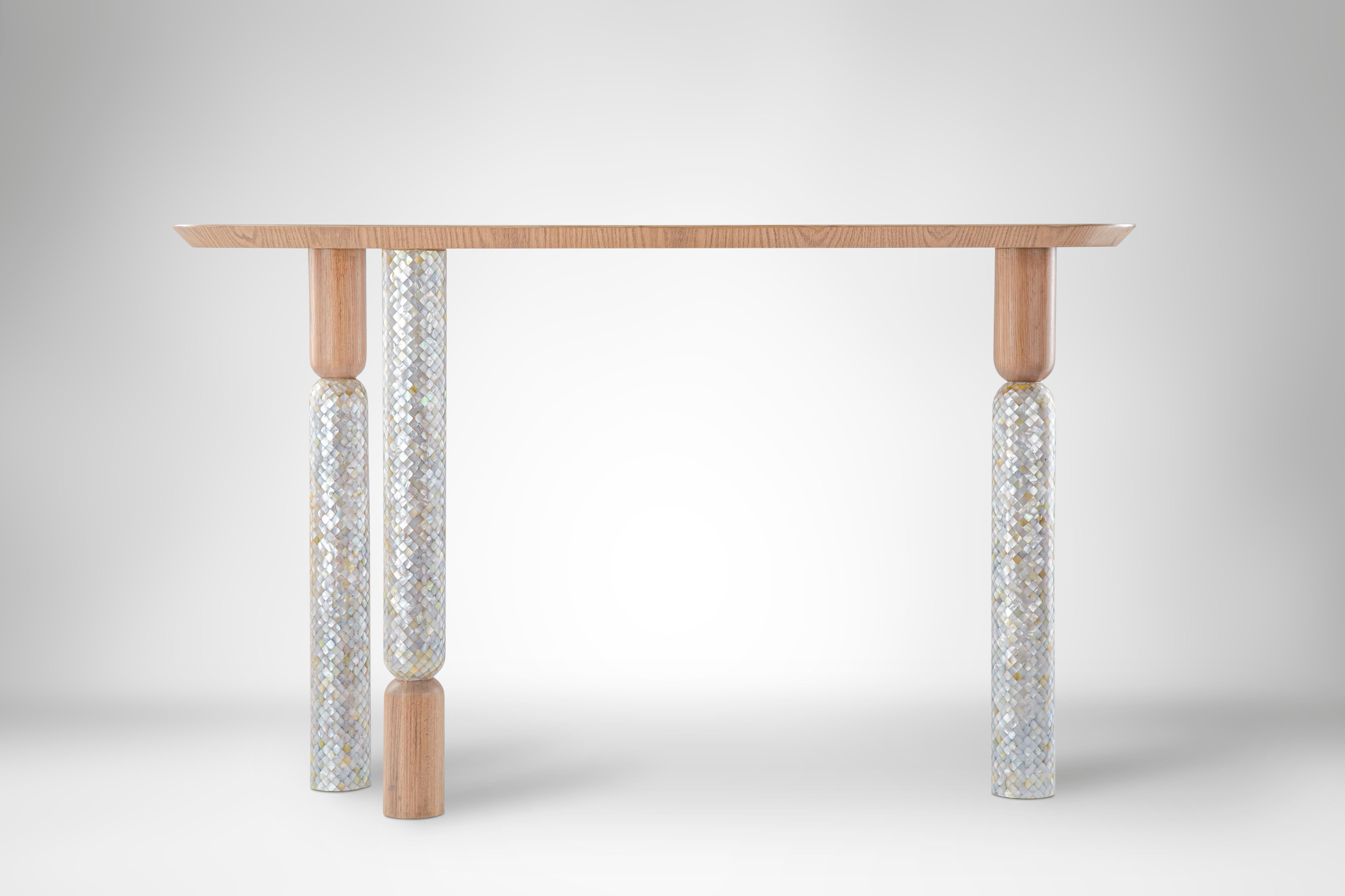 Minimalist Console with Hand-Laid Mother-of-Pearl Legs and Oak Top. 
Lotus comes in many shapes and forms. In our Joy console we abstracted three lotus flowers, perfectly balancing together a clean Oak top in minimalist form. The mother-of-pearl is