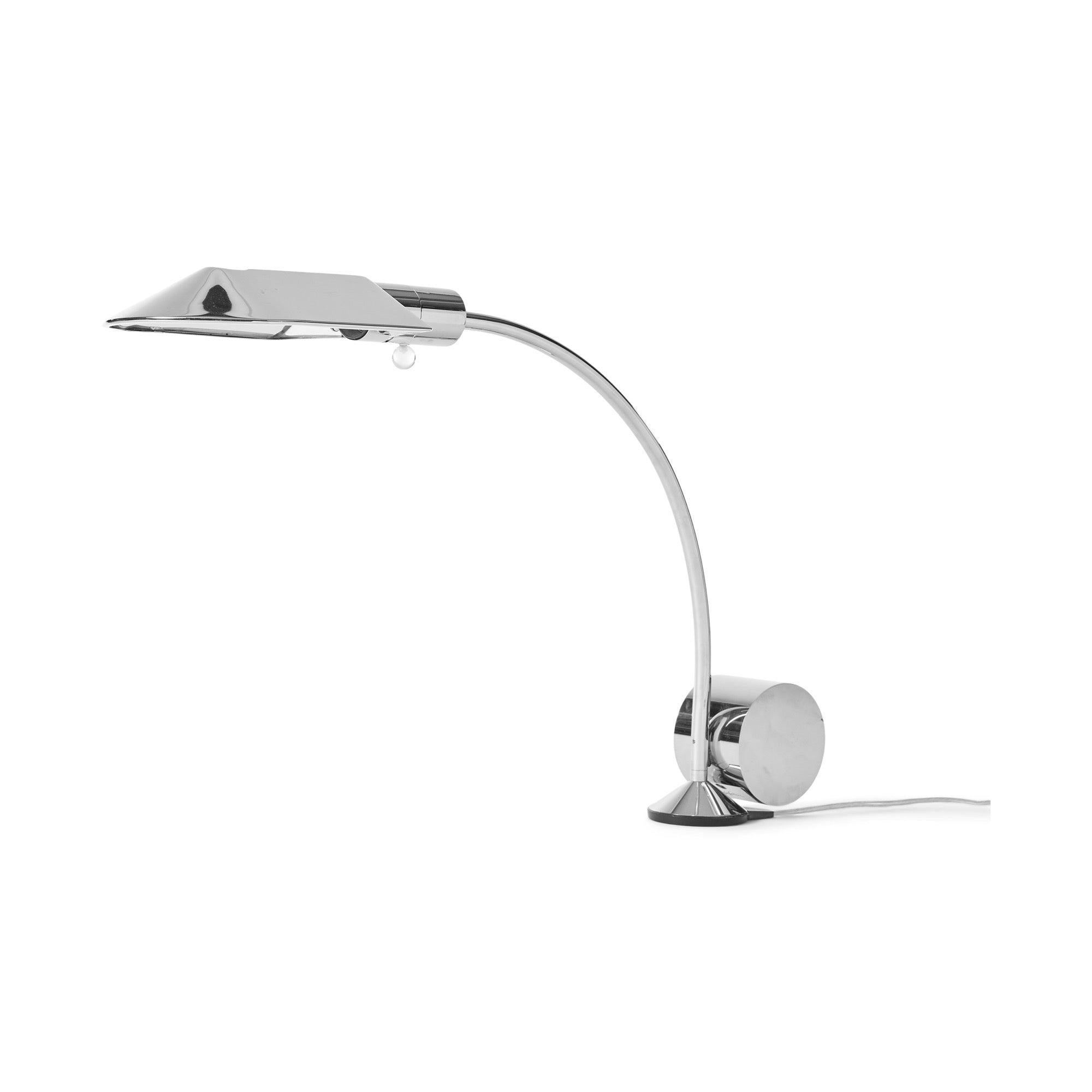 A genius counterweighted chrome desk lamp having a rounded shade and curved chromed arm. The lamp rotates on a round nylon base with a suspended counterweight supporting the shade.