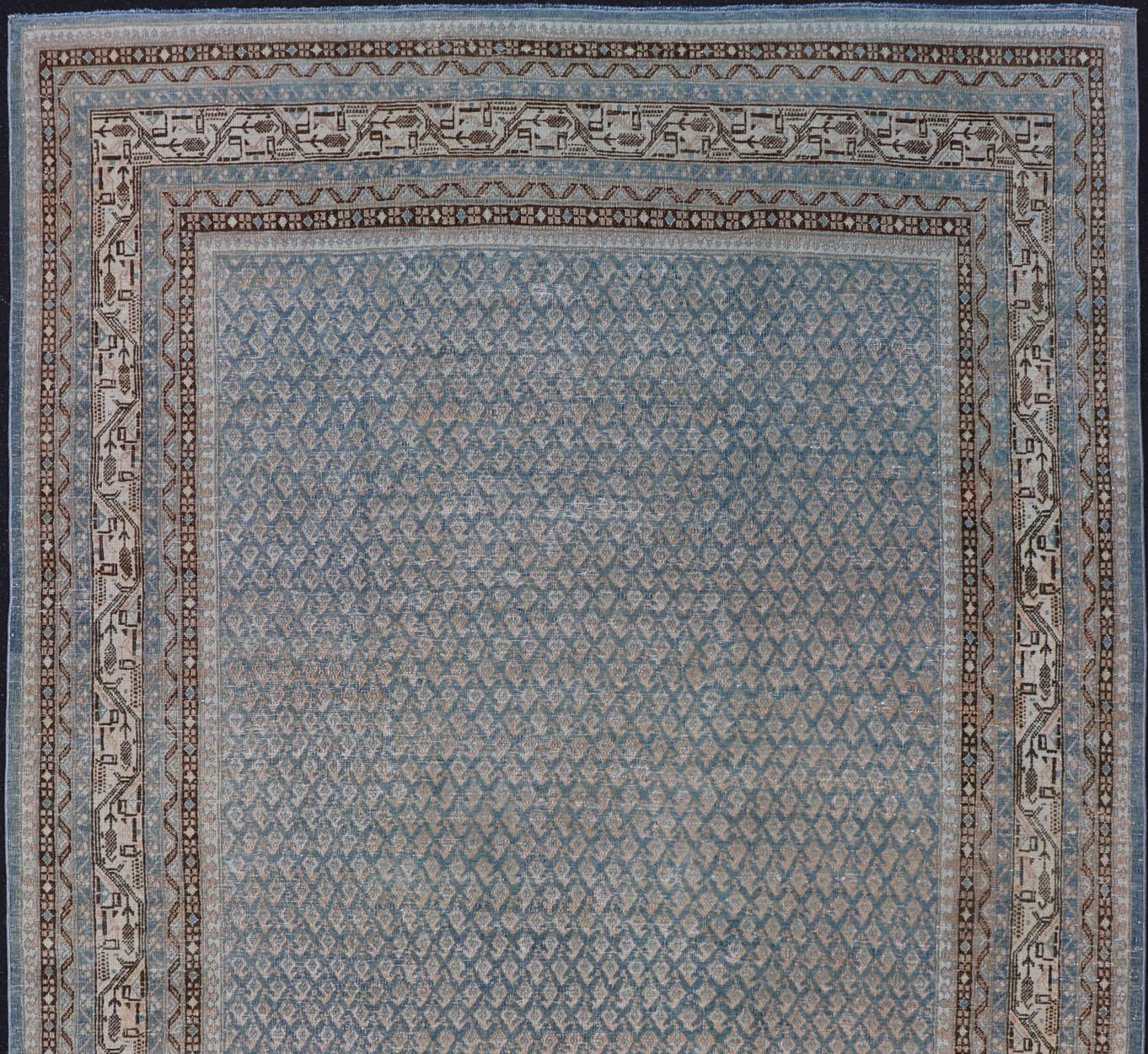 Minimalist antique Persian Tabriz rug with all-over field and light blue, rug EMB-8530-178688, country of origin / type: Iran/ Tabriz, circa 1930.

This Tabriz rug features a relatively intricate and detailed border area and an entirely sparse and