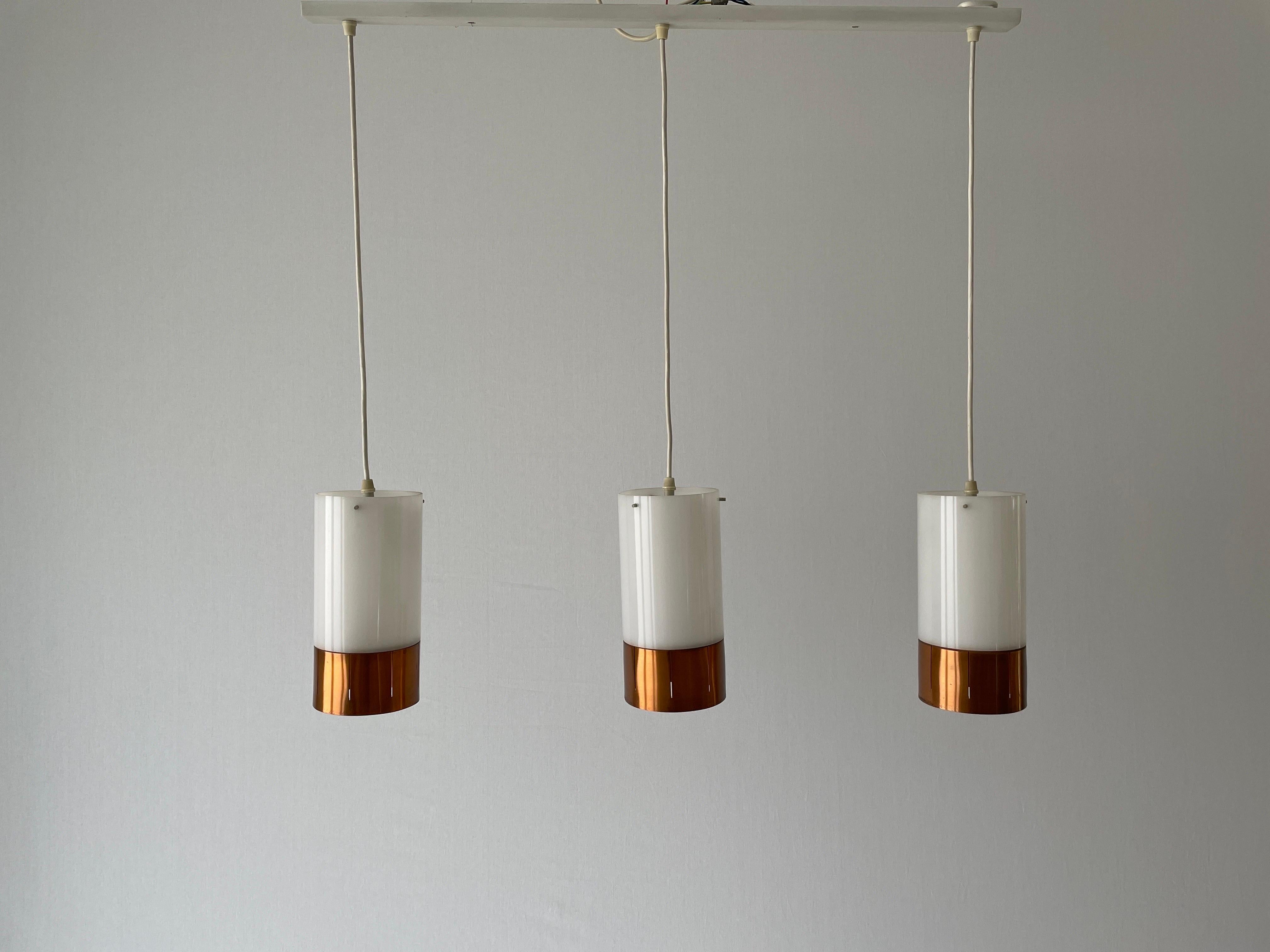 Minimalist Design Copper  Plexiglass Triple Shade Pendant Lamp, 1960s, Germany

Lampshade is in very good vintage condition.

This lamp works with 2x E14 light bulbs. 
Wired and suitable to use with 220V and 110V for all