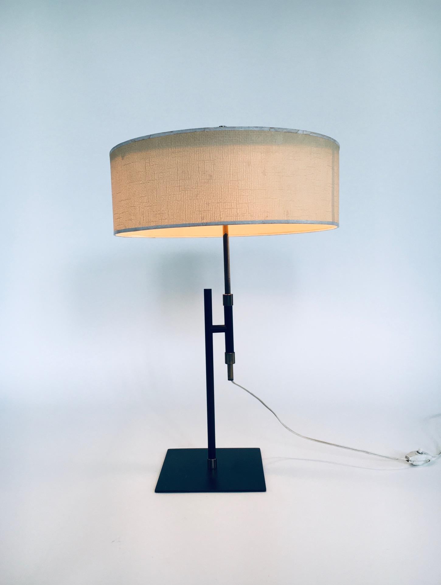 Vintage Midcentury Minimalist Design Table lamp in the manner of Kaiser Idell / Kaiser Leuchten. Made in Germany, 1950's era. Black lacquered metal with brass parts. The difuser on top is white lacquered metal and has it's original cream paper