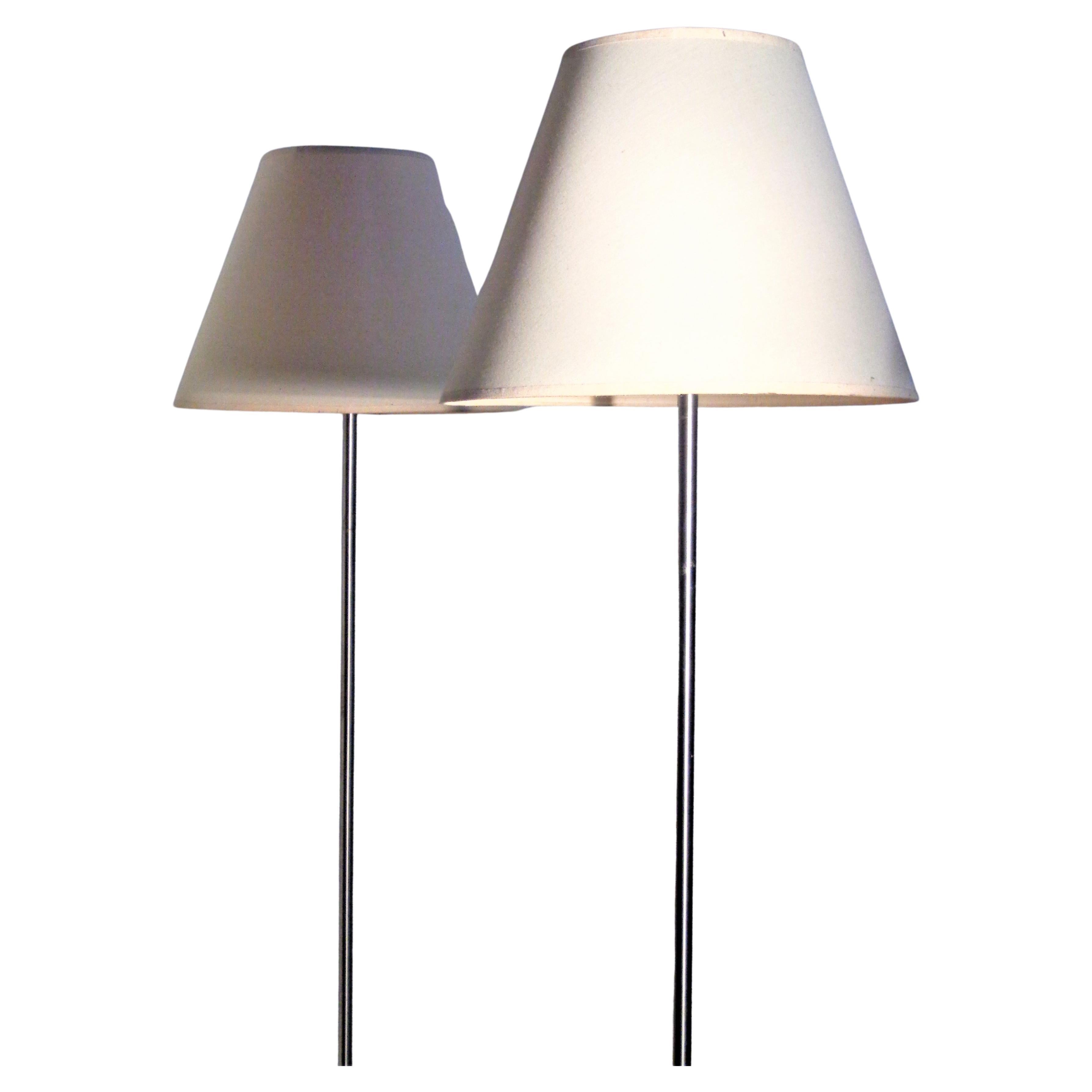 Matching pair of minimalist designed tulip base nickel metal floor lamps by Laurel Lamp Company w/ the original cylindrical nickel finials and cloth shades. Overall very good vintage condition. Circa 1960. Look at all pictures and read condition