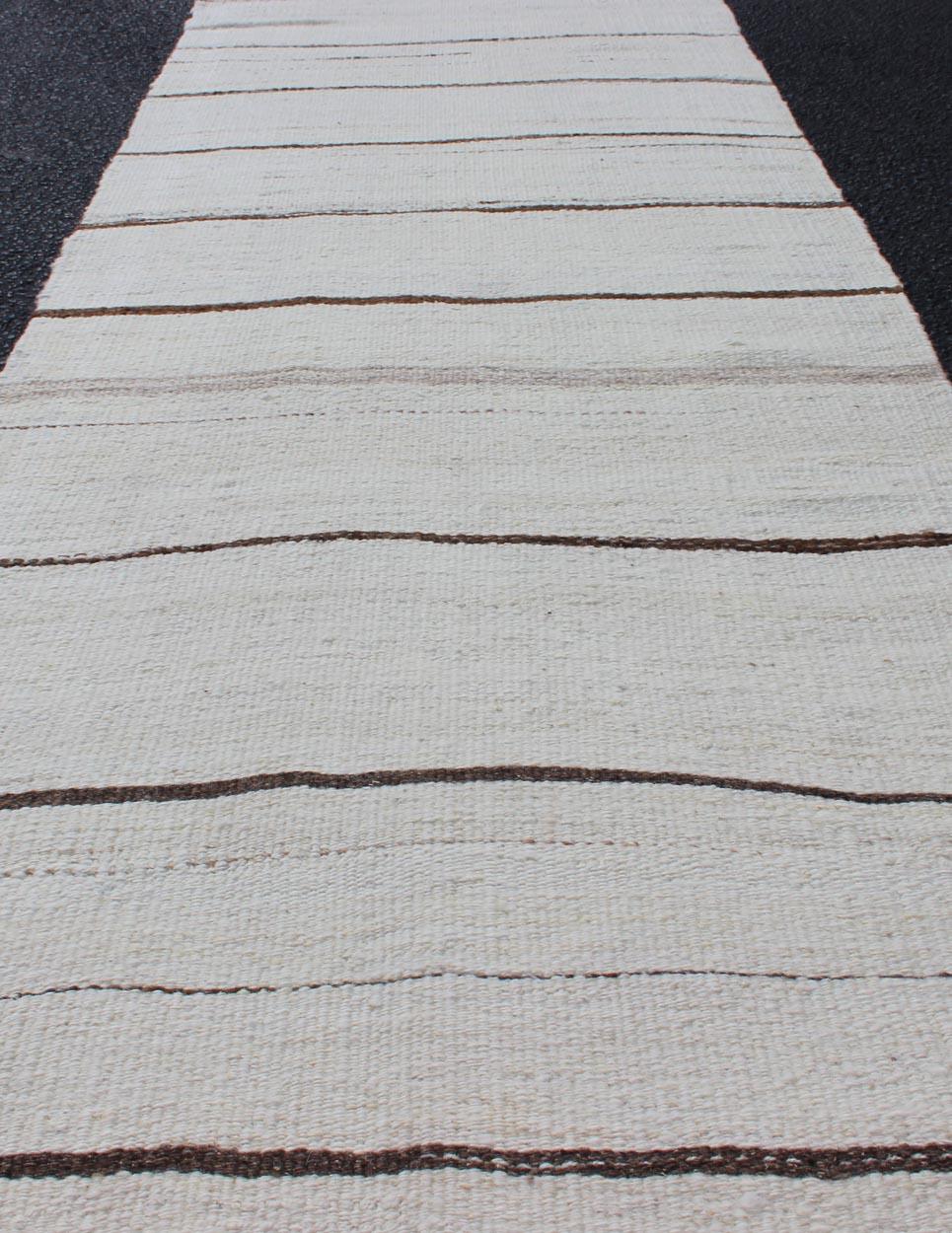Minimalist Design Vintage Turkish Kilim Runner with Creams, Brown and Ivory. Keivan Woven Arts / rug EN-16, country of origin / type: Turkey / Kilim, circa 1950

Measures: 2' x 8' 

This flat-woven Kilim runner from Turkey features an understated