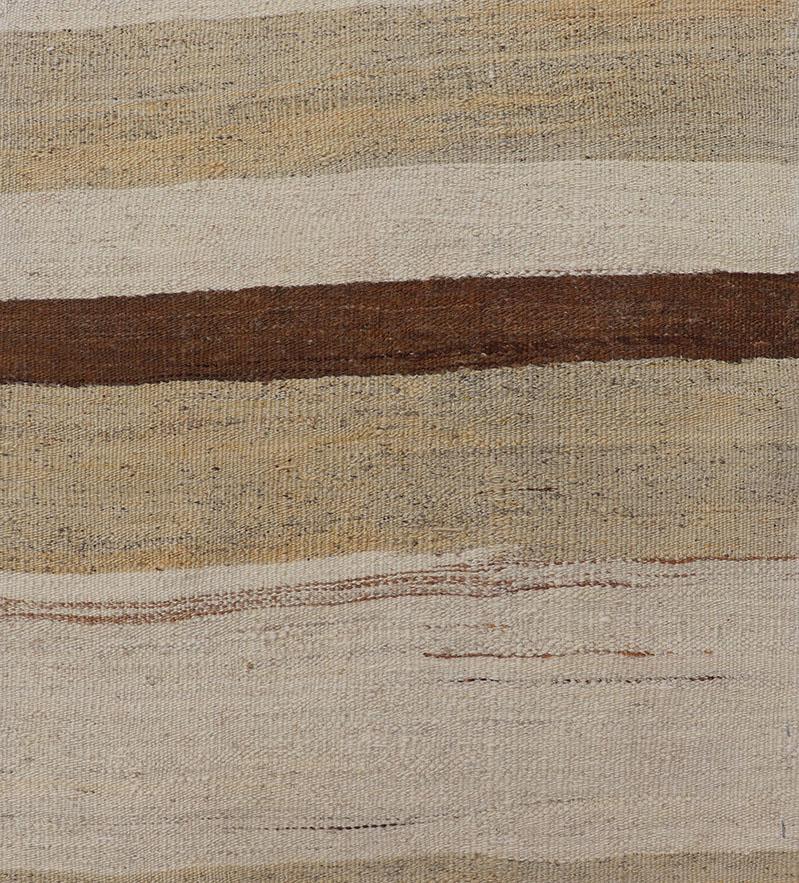 Minimalist design with traces of stripes Kilim runner in cream, light brown and taupe, Keivan Woven Arts / rug EN-179919, country of origin / type: Turkey / Kilim, circa 1950
Measures: 2'2 x 9.
This flat-woven Kilim runner from Turkey features an
