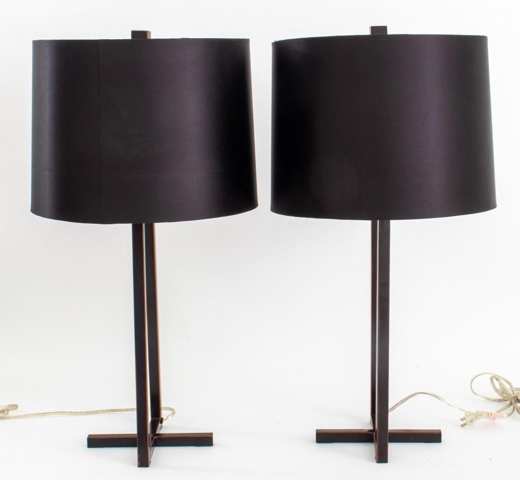 Pair of minimalist table lamps with black shade, raised on ebonized metal X base. Set of 2.

Dimensions: Each: 28.5