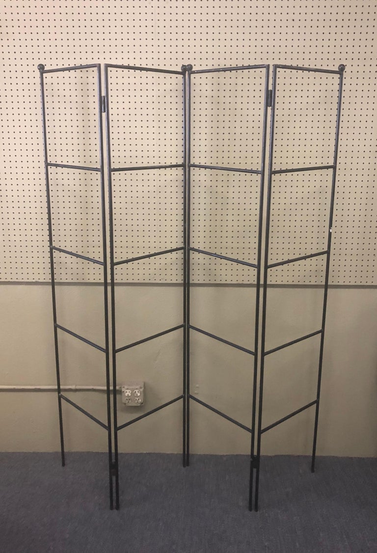 A very cool and simple Minimalist four-panel wrought iron room divider / screen, circa 1970s. The screen is split into two pieces with two panels each and can be used separately or together. Each panel is 16