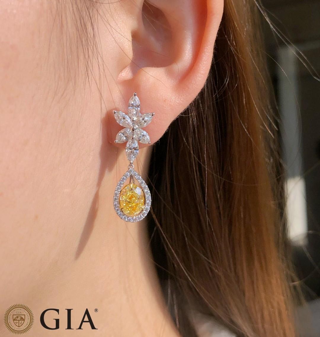 Oval Cut Minimalist GIA-certified 2-carat oval-cut fancy yellow diamond earrings For Sale