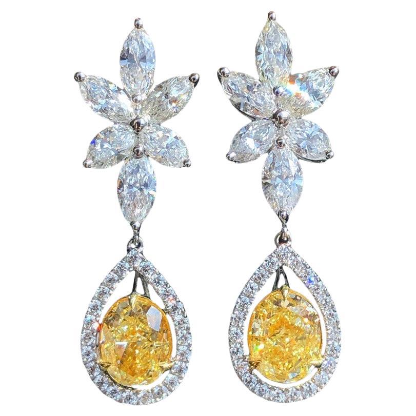 Minimalist GIA-certified 2-carat oval-cut fancy yellow diamond earrings For Sale