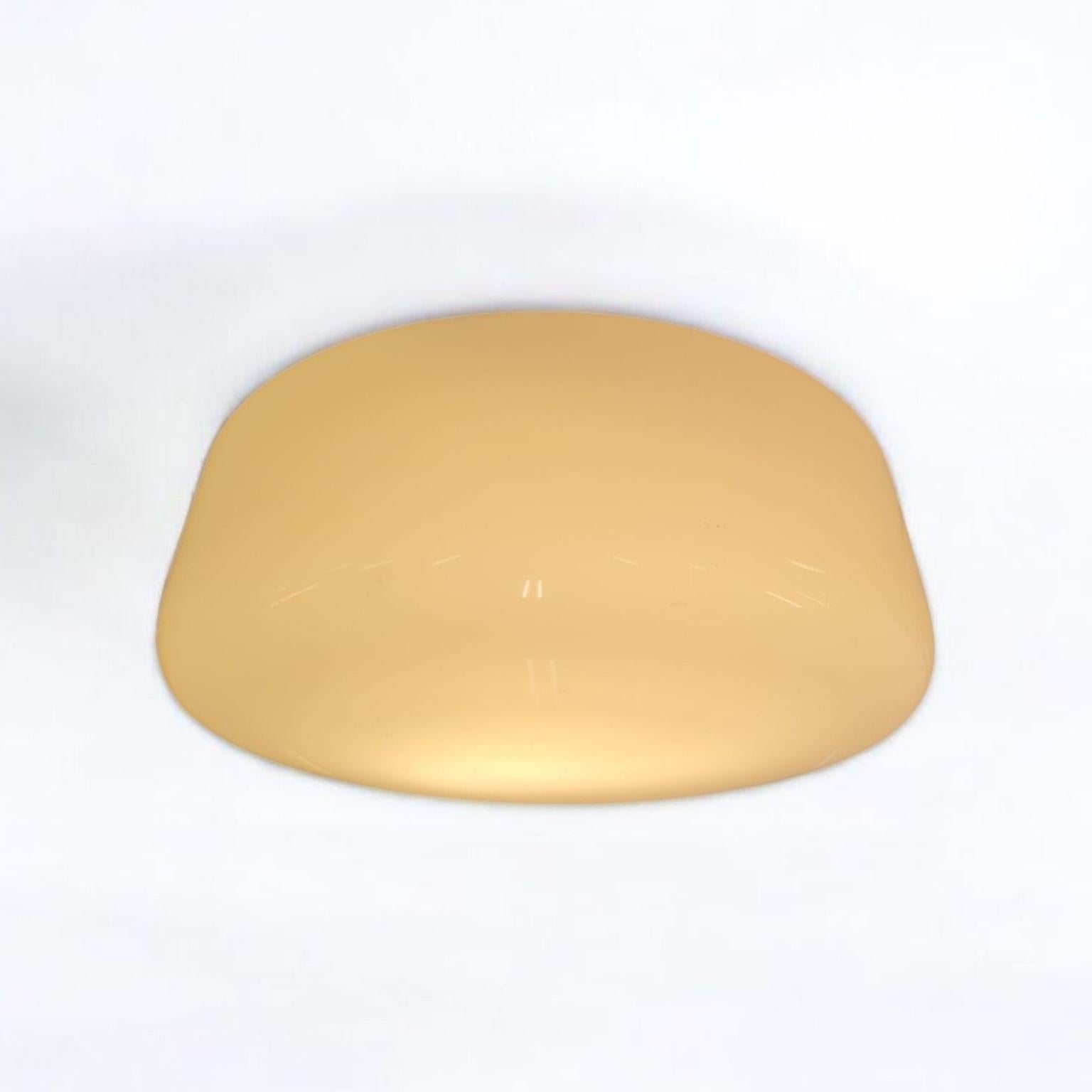 A minimalist flushmount with a metal base and a white opaline glass shade designed by Gunilla Jung and manufactured by Orno Oy in Finland in the 1950s. The lamp is in it's full original condition and stamped Orno and also (patent pending) which