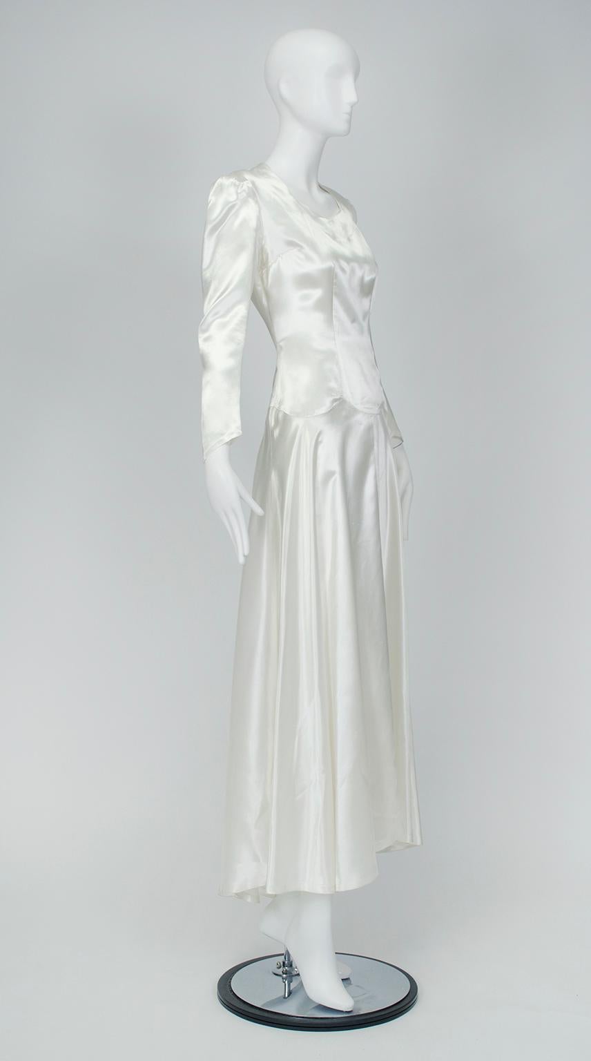 When wartime rationing abbreviated garment lengths, brides used intricate seams and sharp tailoring to create interest in favor of volume. This shimmering example incorporates a scalloped waist seam and military shoulders to create a simple but
