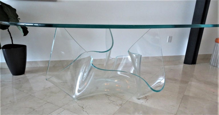 Visual artist, Laurel Fyfe (1956-2011), created the Aurora Glass Dining Table, a monumental and rare 3/4″ thick sapphire glass fazzoletto or handkerchief shape base supporting (rubber cushions in between) a large amorphous glass top. Produced in the
